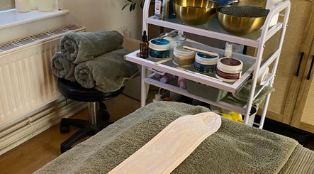 Cozy treatment setup at Serene Holistics And Beauty, Shrewsbury, England, GB with towels and spa products.