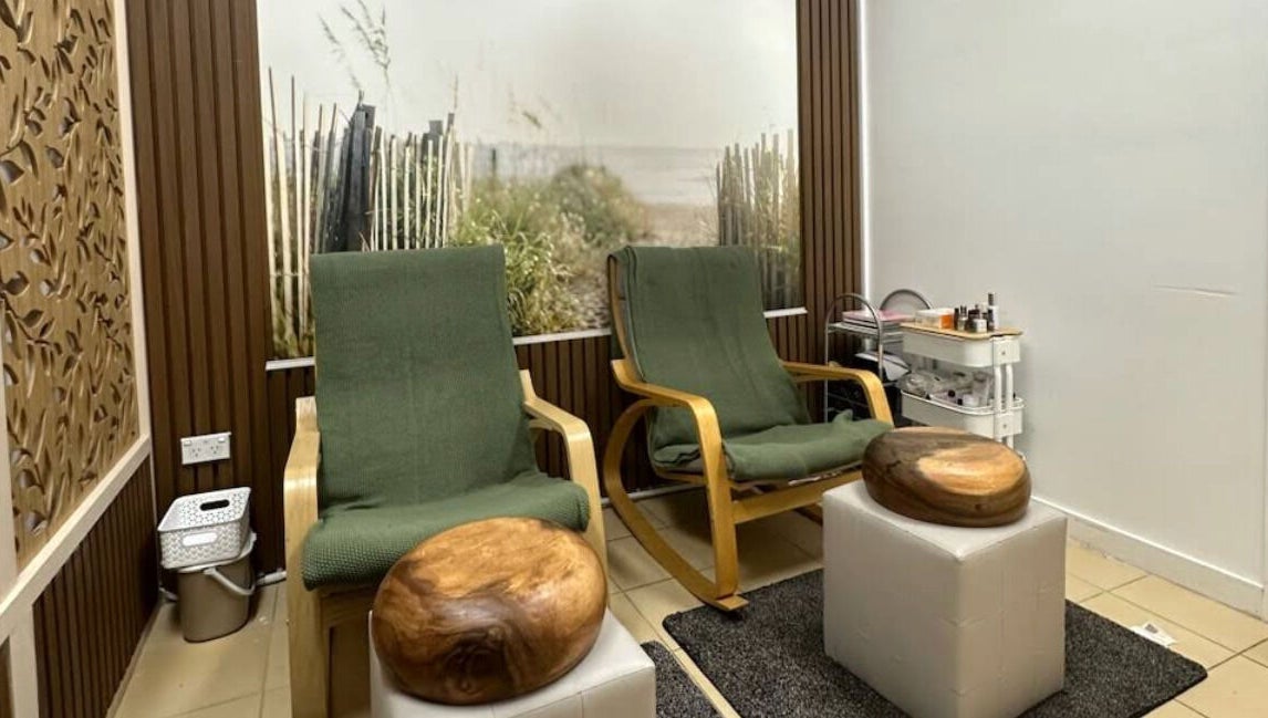 Relaxing chairs at Shape and Glow, Blacktown, NSW, AU, with decorative wall and wellness setup.