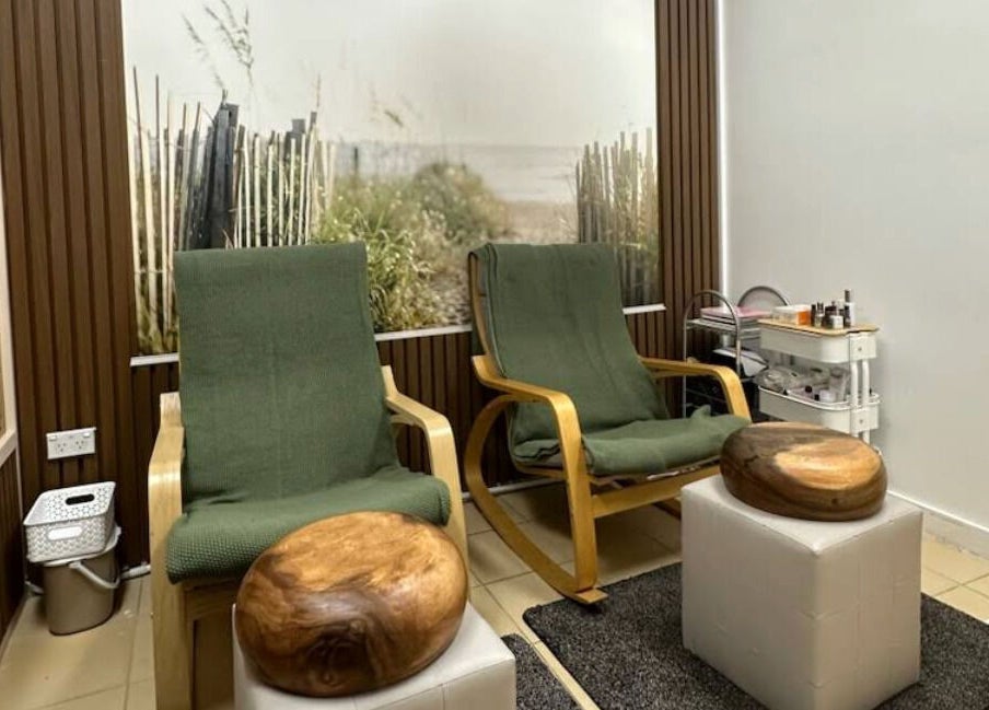 Relaxing chairs at Shape and Glow, Blacktown, NSW, AU, with decorative wall and wellness setup.