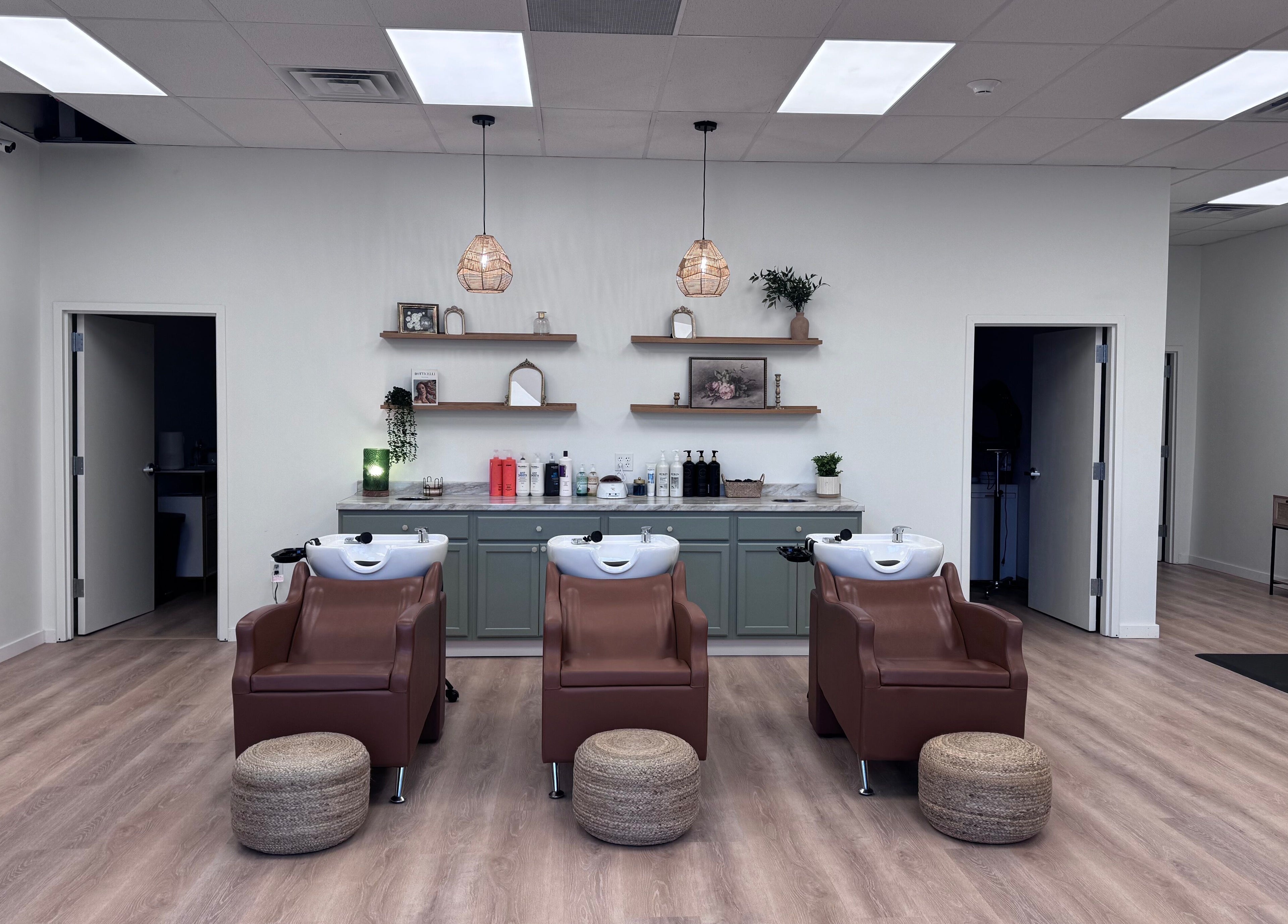 Chic wash station at Ellie Salon in Old Forge, Pennsylvania, US featuring plush chairs and elegant decor.