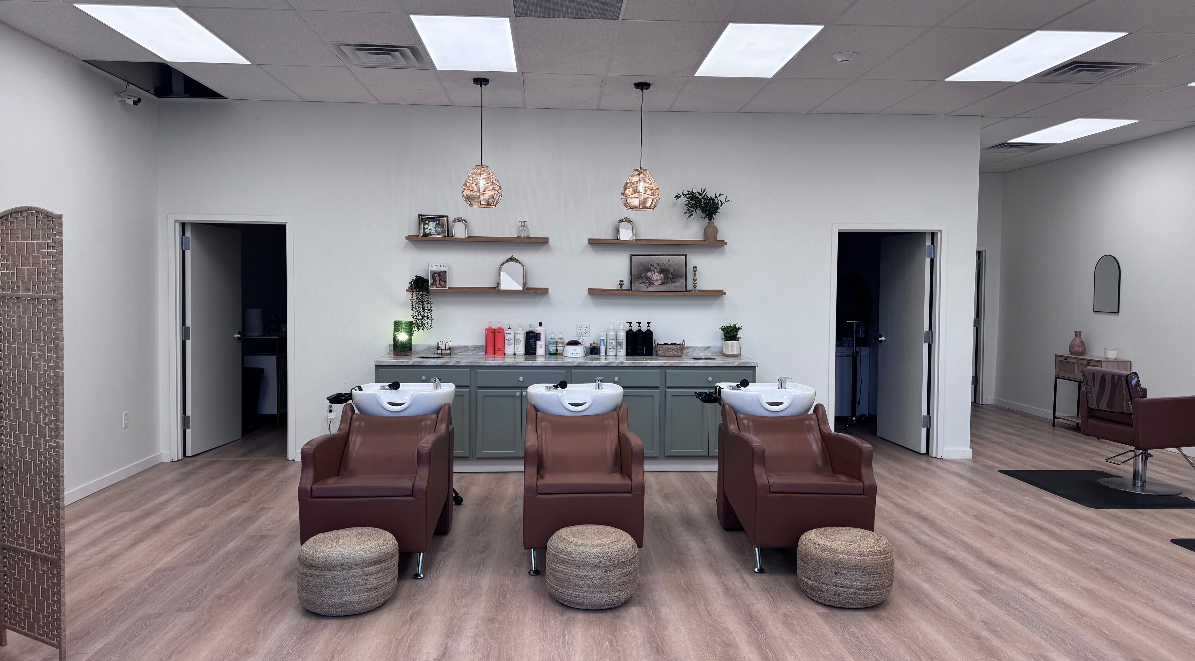 Chic wash station at Ellie Salon in Old Forge, Pennsylvania, US featuring plush chairs and elegant decor.
