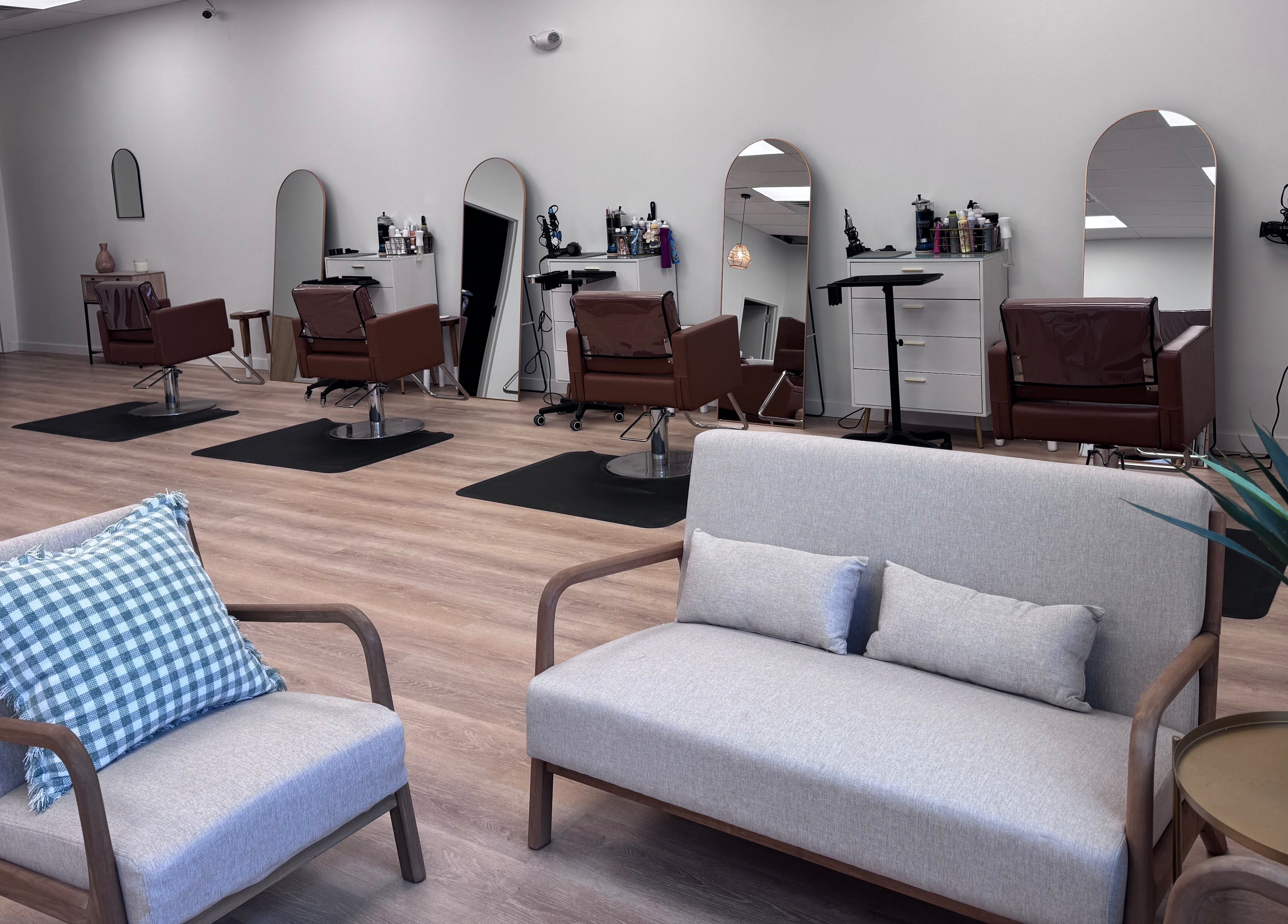 Modern interior of Ellie Salon in Old Forge, Pennsylvania, US, featuring plush seating and elegant styling stations.