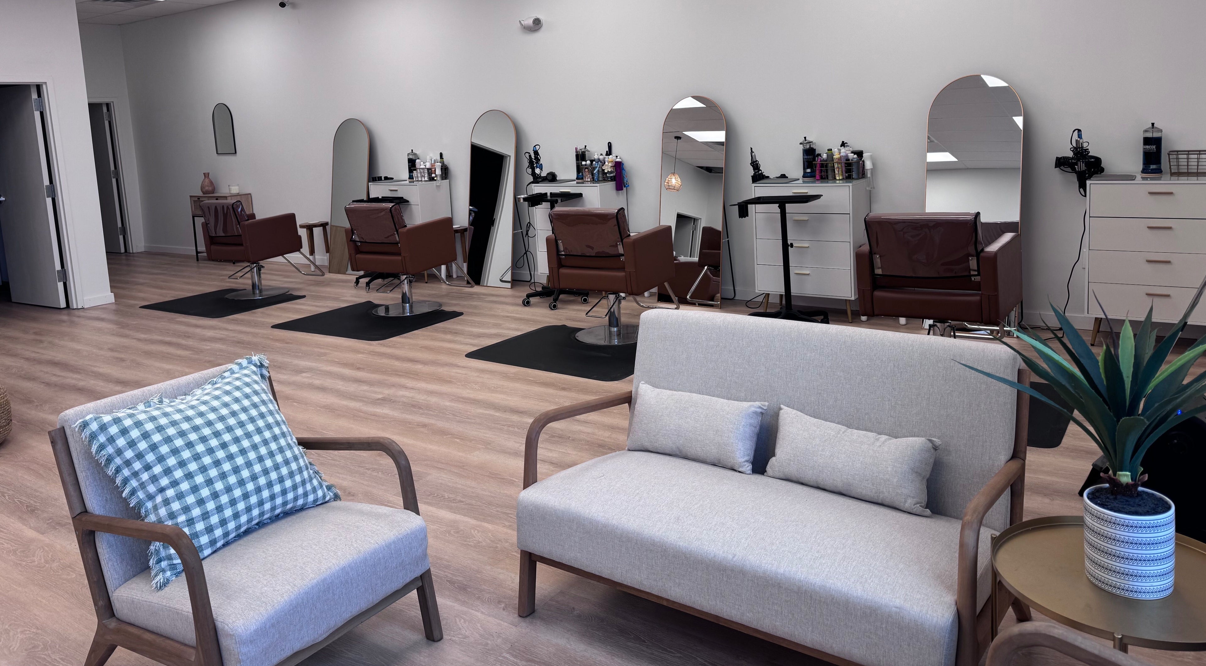 Modern interior of Ellie Salon in Old Forge, Pennsylvania, US, featuring plush seating and elegant styling stations.