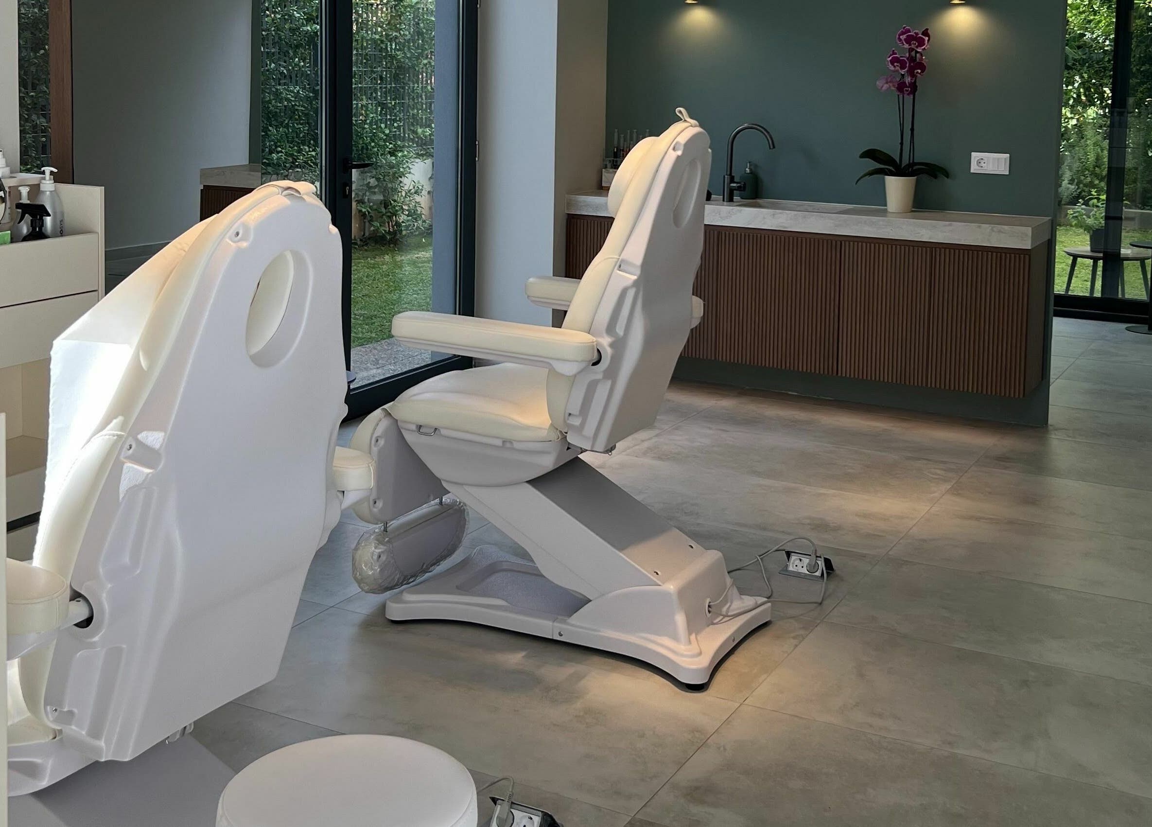 Tranquil treatment room at Face It Mind Skin Bar, Glifada, GR, featuring comfortable chairs and modern decor.