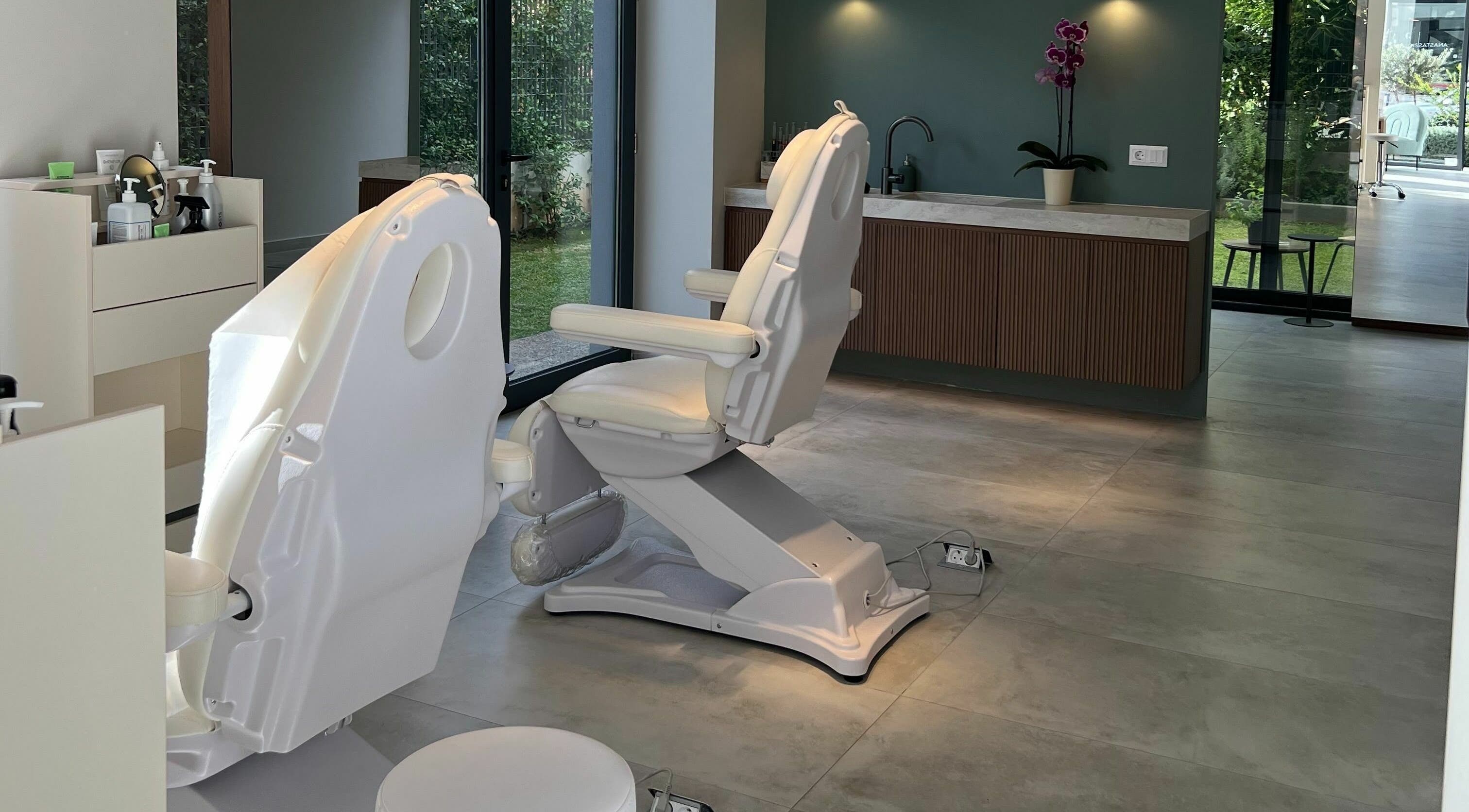 Tranquil treatment room at Face It Mind Skin Bar, Glifada, GR, featuring comfortable chairs and modern decor.