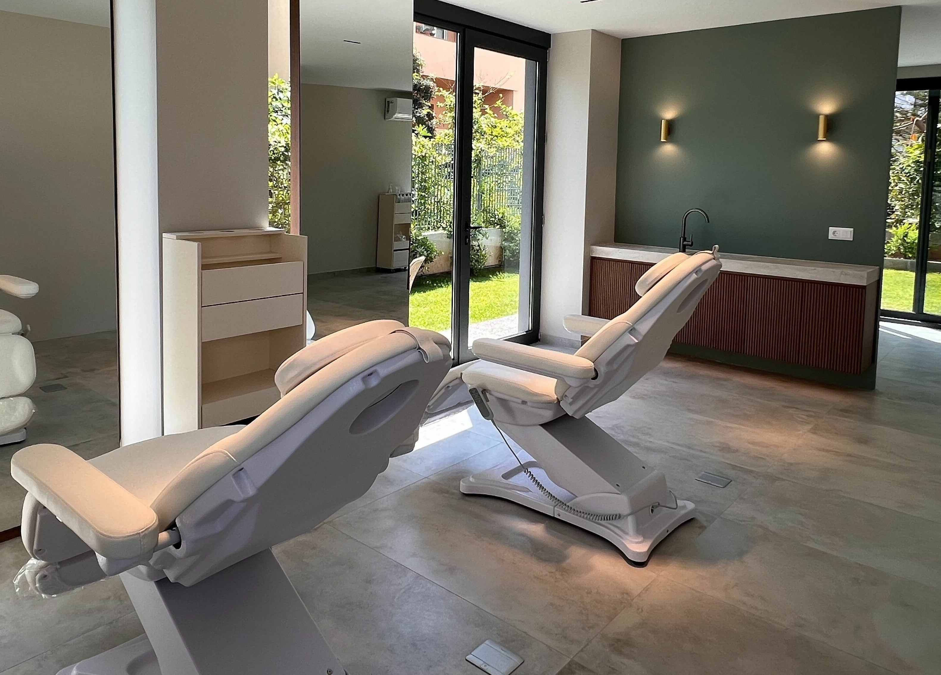 Relaxing treatment room at Face It Mind Skin Bar in Glifada, GR featuring plush chairs and natural light.