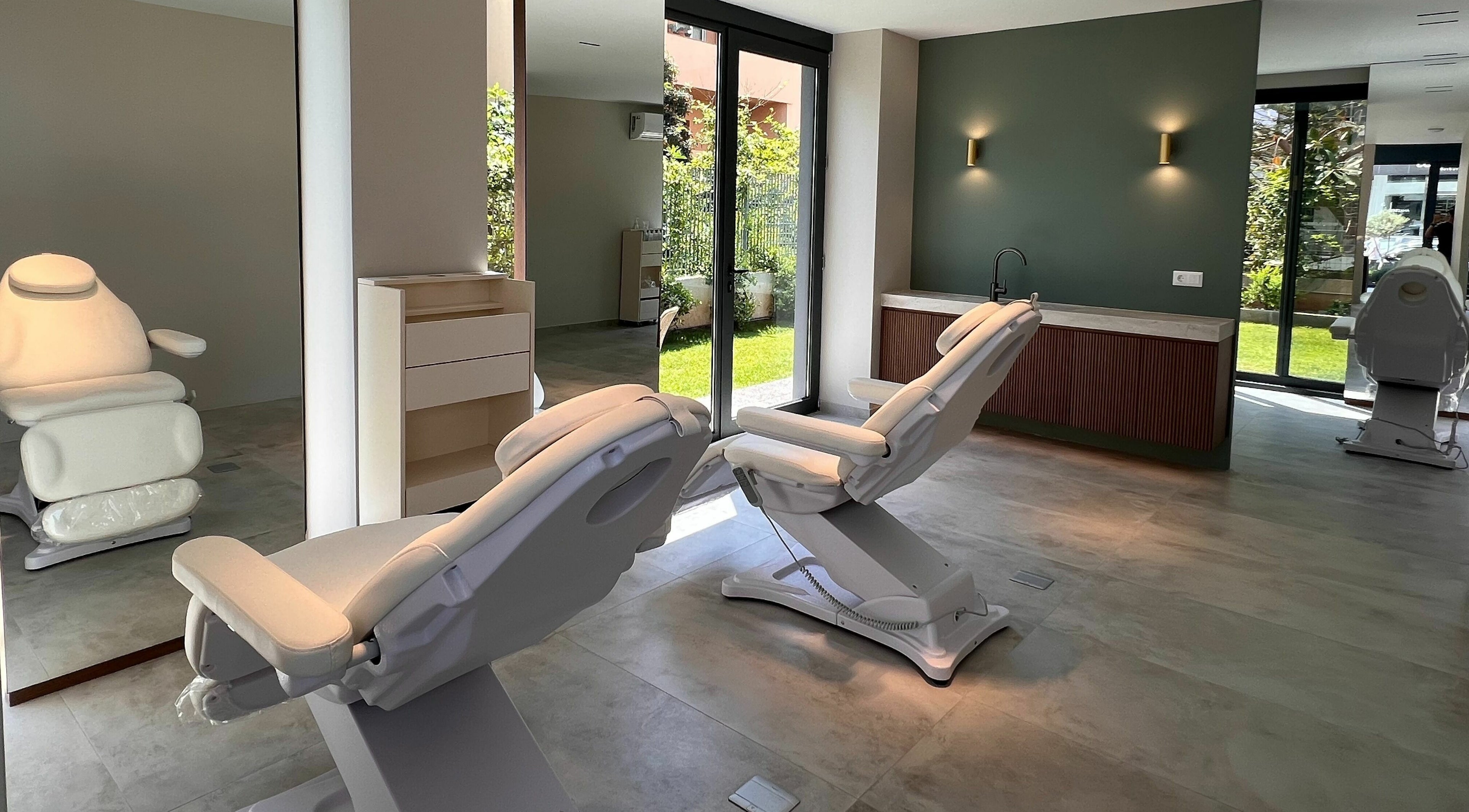 Relaxing treatment room at Face It Mind Skin Bar in Glifada, GR featuring plush chairs and natural light.