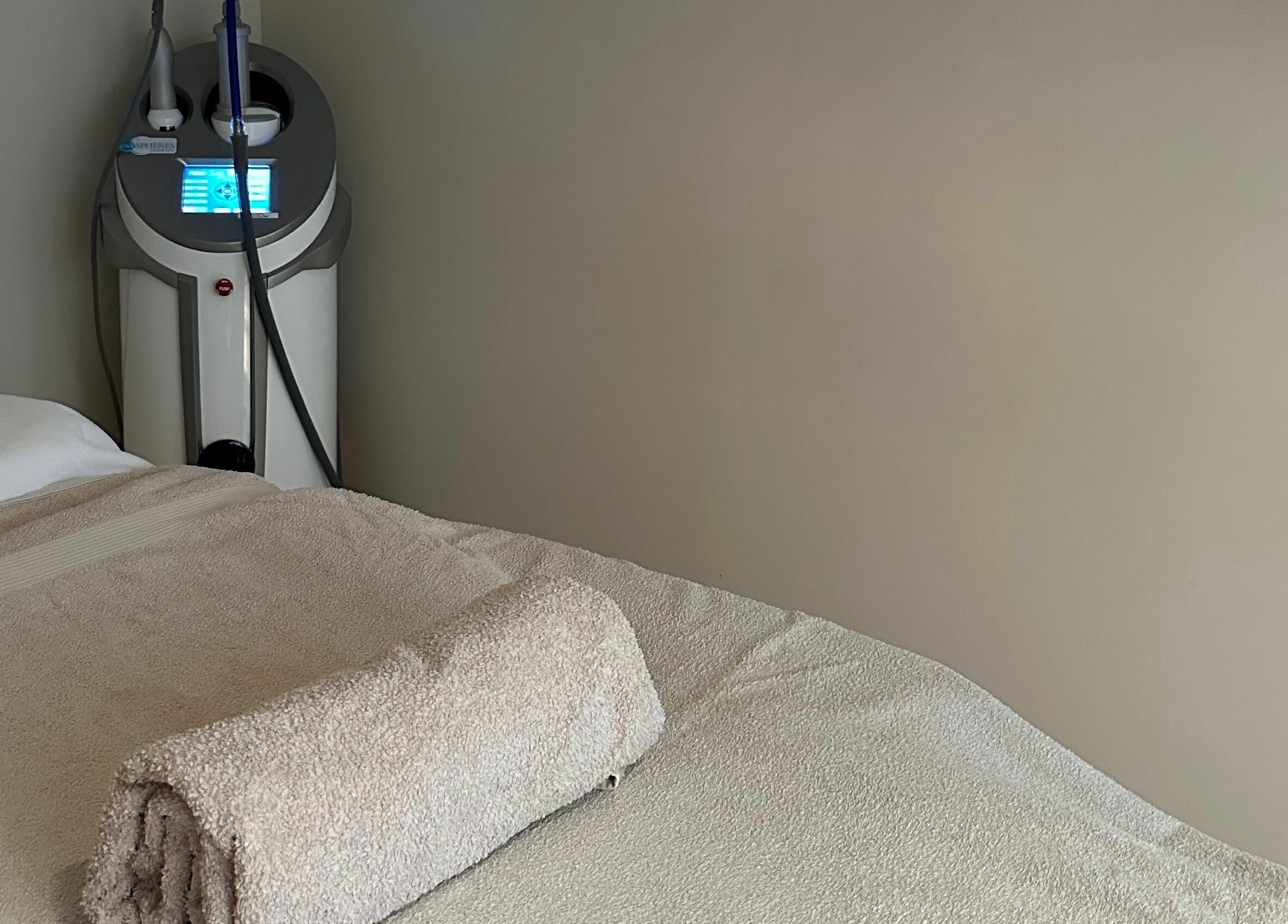 Relaxing treatment room at Face It Mind Skin Bar in Glifada, GR, featuring a plush massage table.