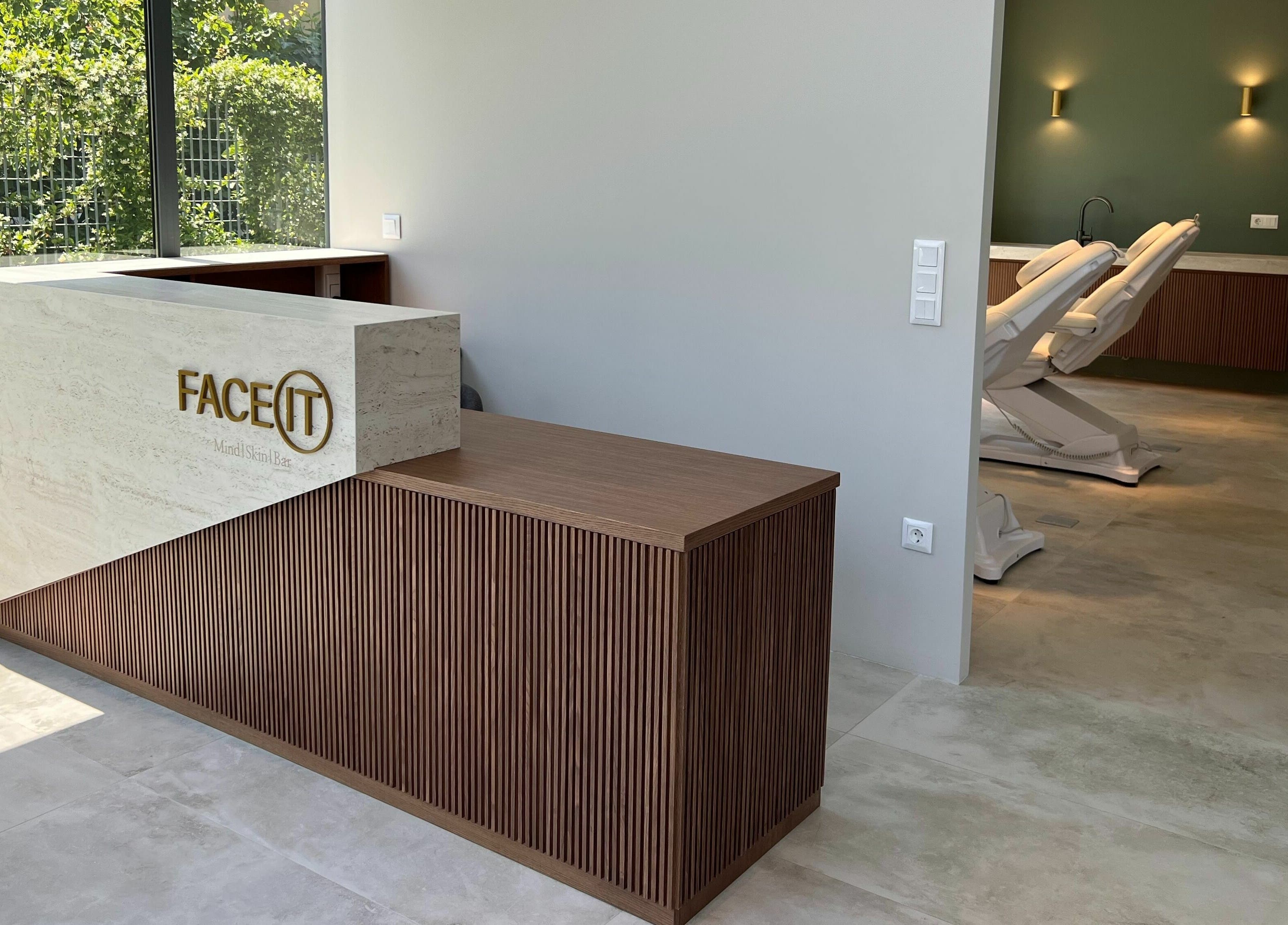 Reception area at Face It Mind Skin Bar in Glifada, GR with modern decor and treatment rooms in view.