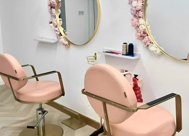 Modern pink salon chairs in House of Beauty, Nuneaton, England, GB, with floral mirrors.