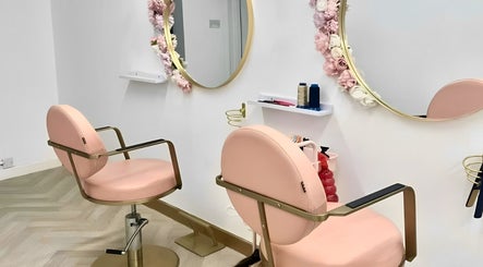Modern pink salon chairs in House of Beauty, Nuneaton, England, GB, with floral mirrors.