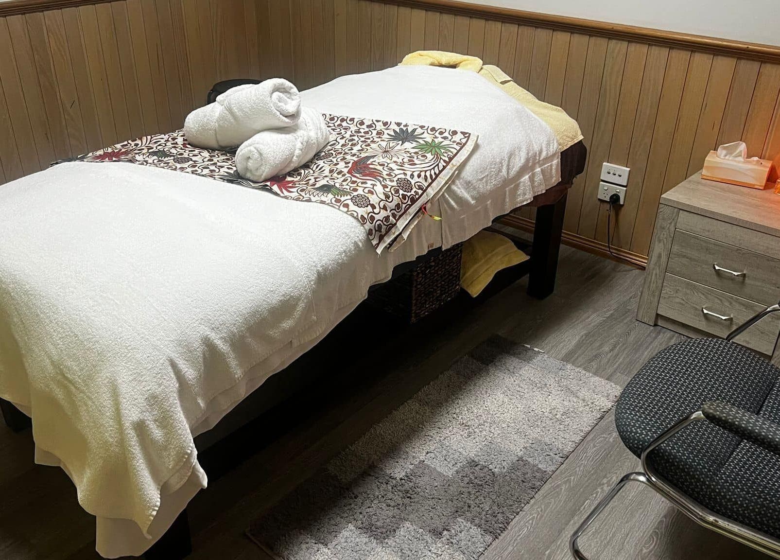 Massage room at Lemon Essential Massage & Spa Shepparton, Victoria with cozy bed and ambient lighting.