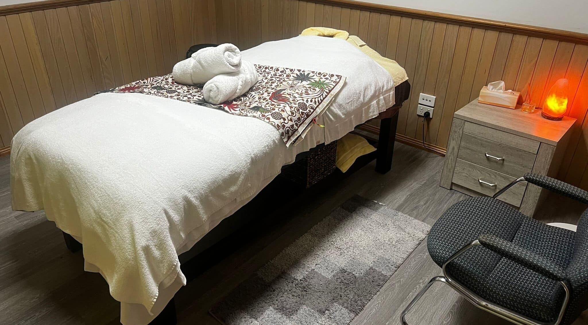 Massage room at Lemon Essential Massage & Spa Shepparton, Victoria with cozy bed and ambient lighting.