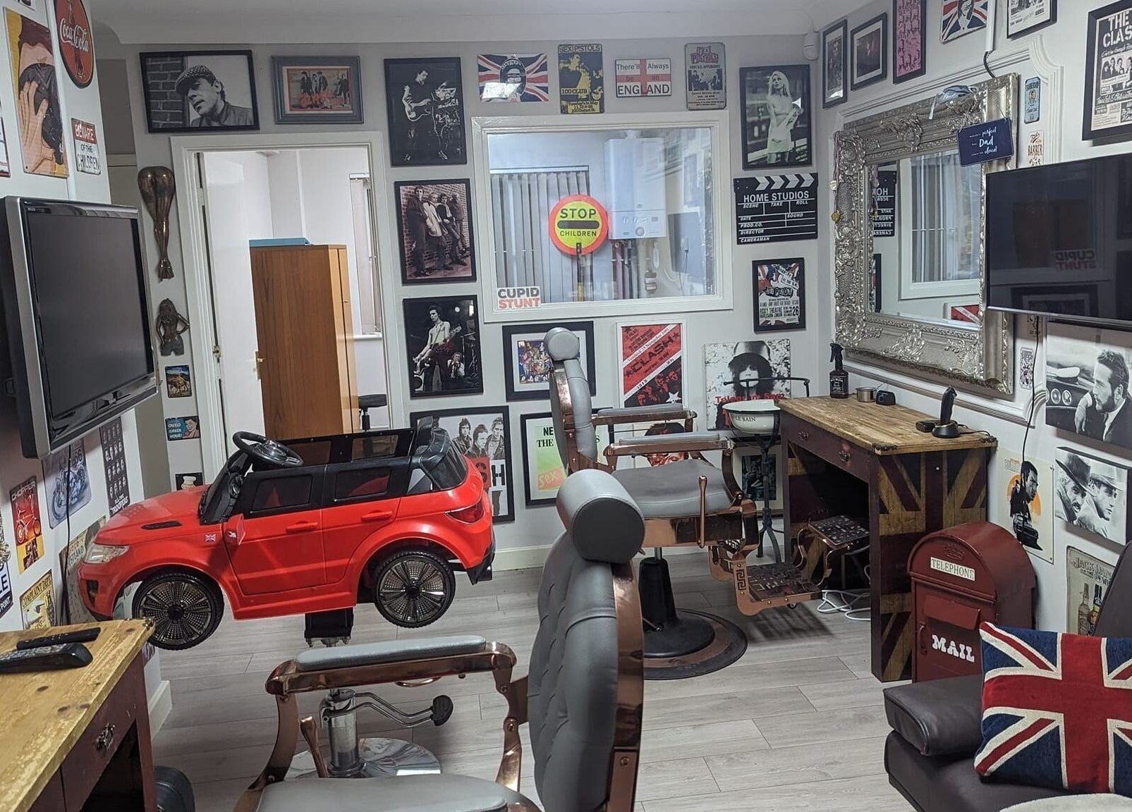 Fred's Barbers eclectic decor with vintage chairs and retro accents in Crawley, England, GB.