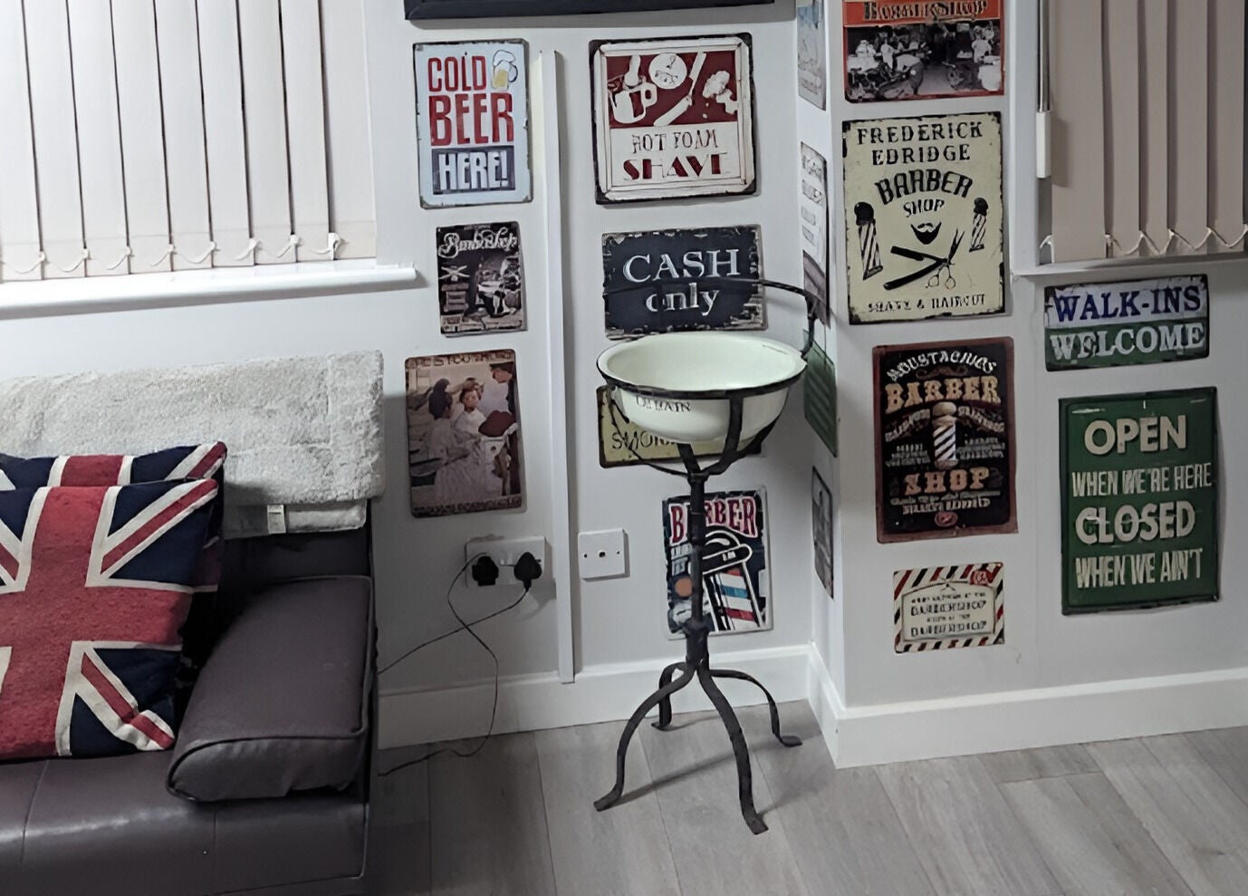 Cozy corner at Fred's Barbers Crawley, England with vintage decor and union jack cushions.