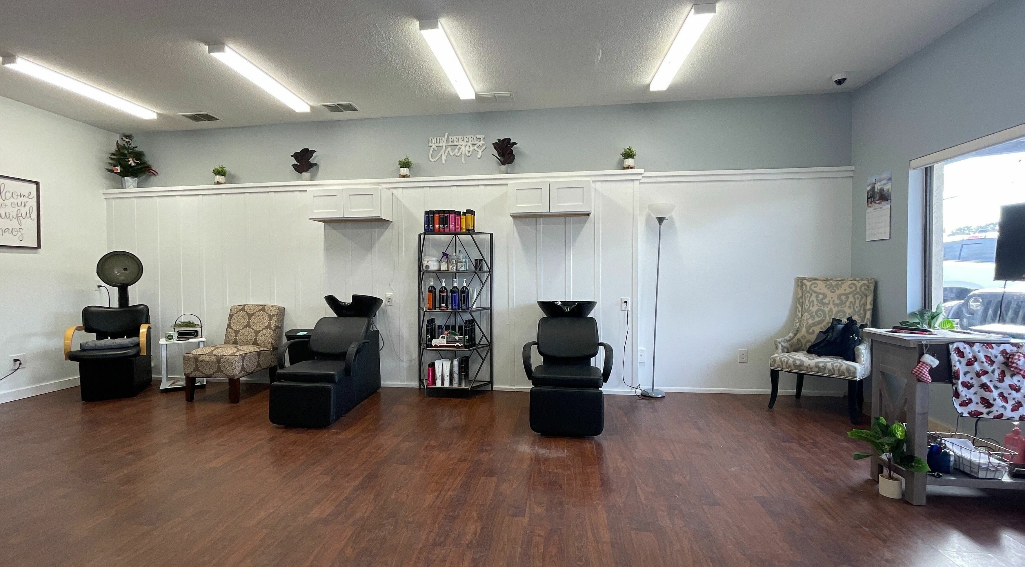 Spacious interior of Chaos Hair Design in Homosassa, Florida, US with modern salon chairs and product display.