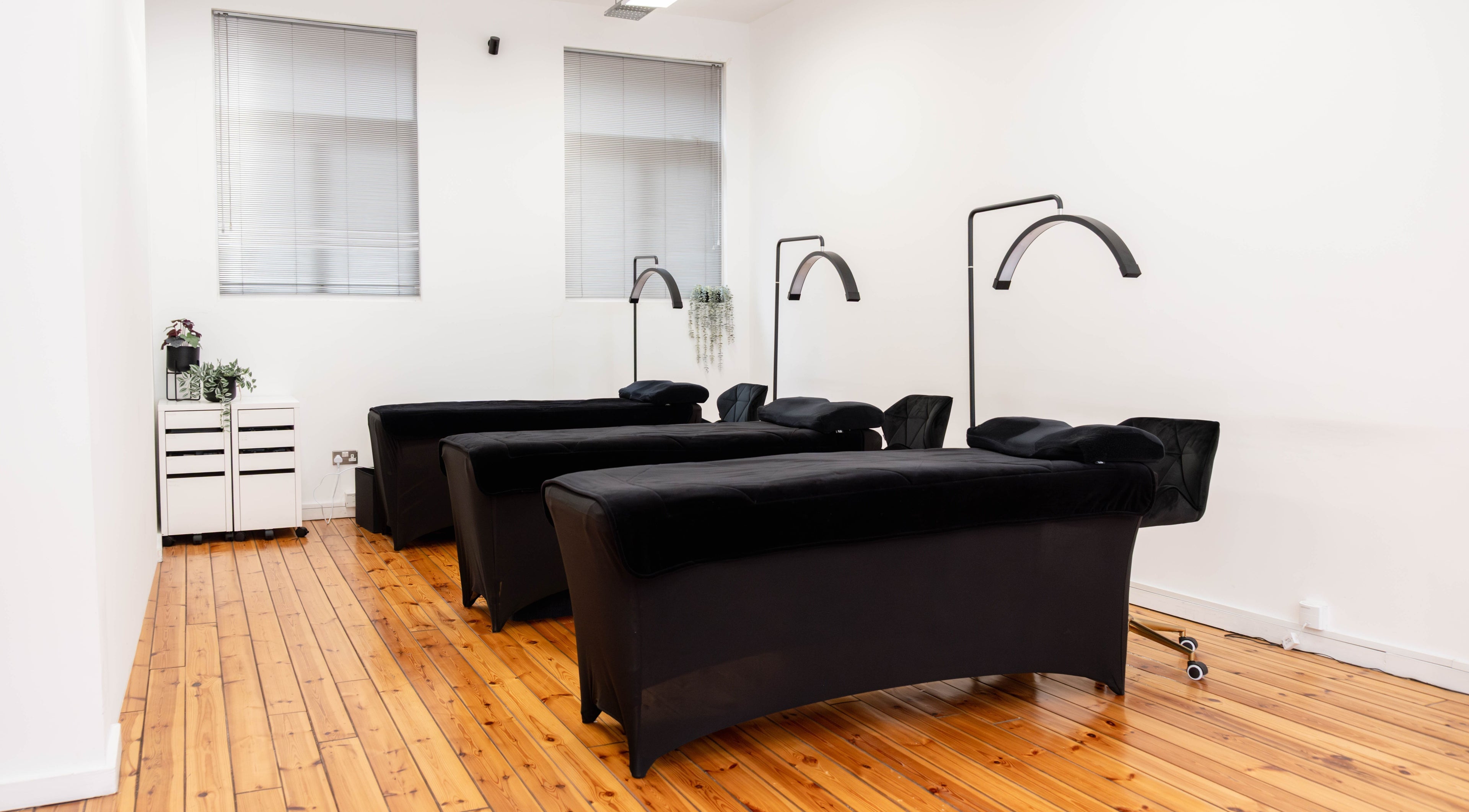 Polly Lashes & Brows London, sleek treatment room with plush black chairs in London, England, GB.