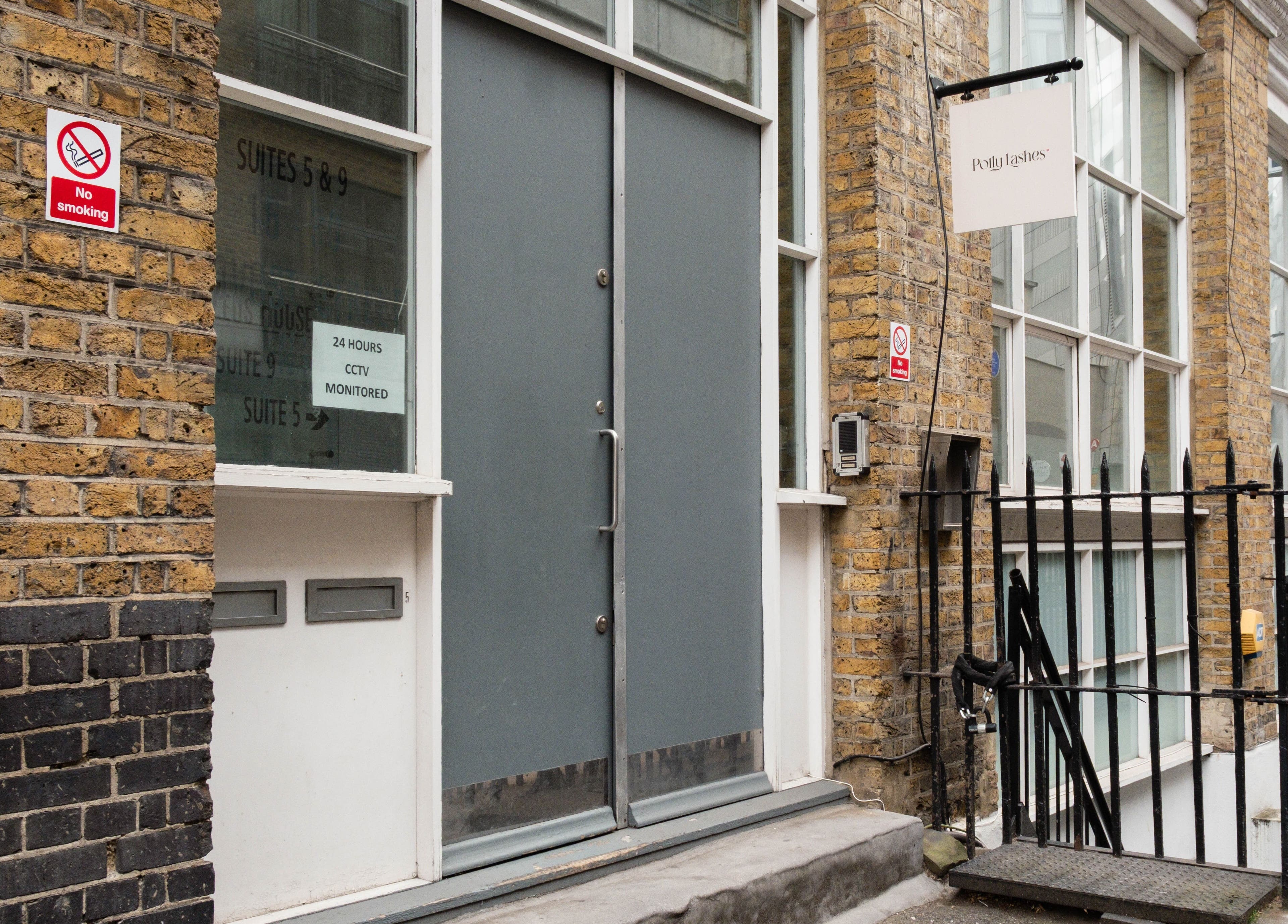 Entrance of Polly Lashes & Brows London, located in a brick building in London, England, GB.