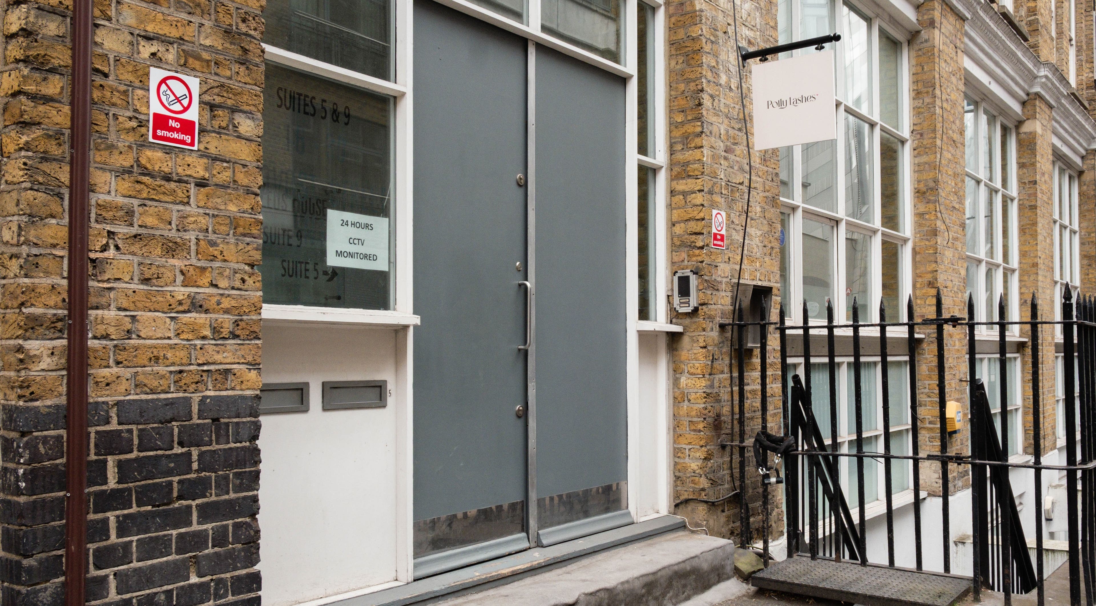 Entrance of Polly Lashes & Brows London, located in a brick building in London, England, GB.