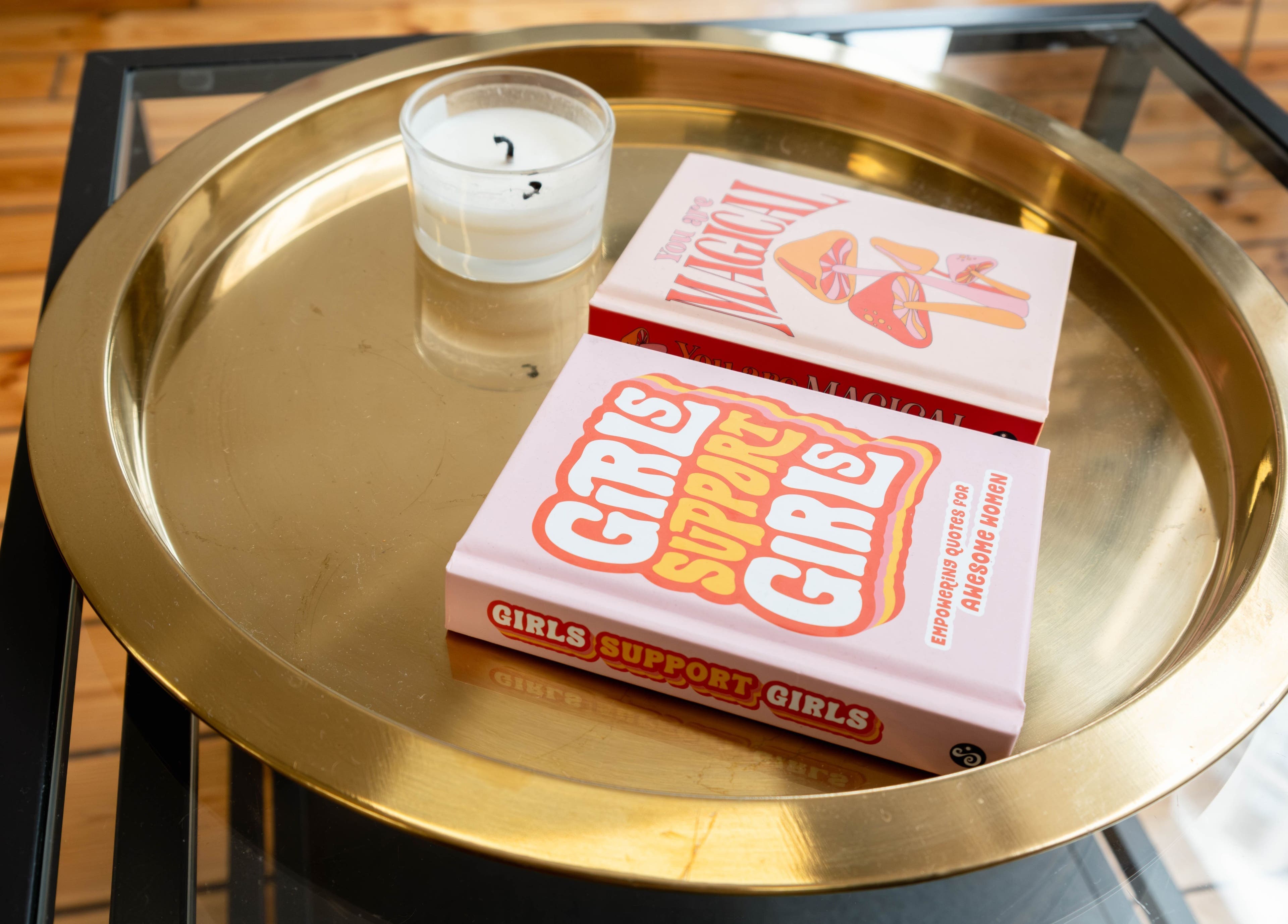Golden tray with books and candle at Polly Lashes & Brows London, London, England, GB.