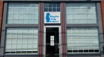 Front entrance of Kingston Body Wellness in Kingston, Georgia, US with prominent signage.