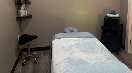 Cozy massage room at Kingston Body Wellness in Kingston, Georgia, US with soothing lighting and a comfortable table.