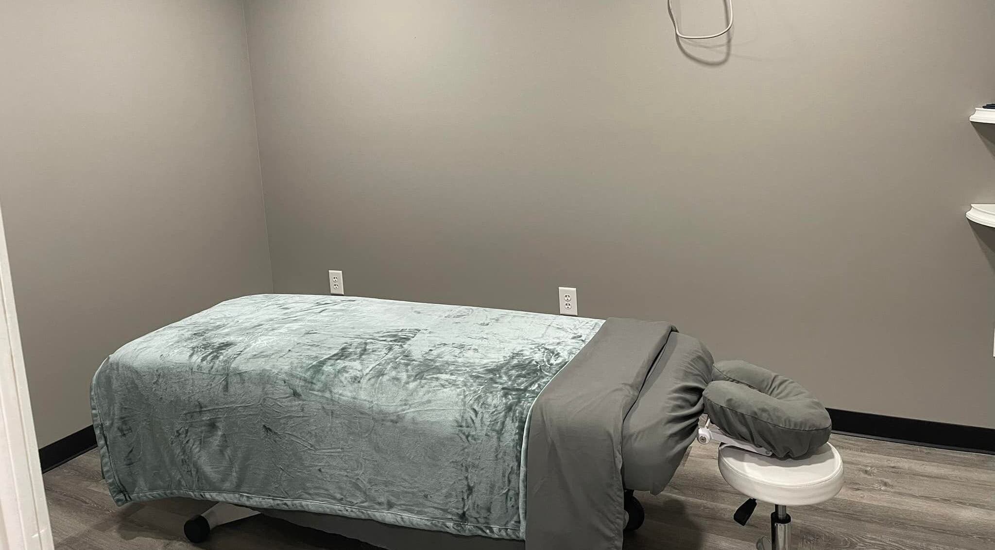 Massage room at Kingston Body Wellness, Kingston, Georgia, US, with a massage table and calming decor.