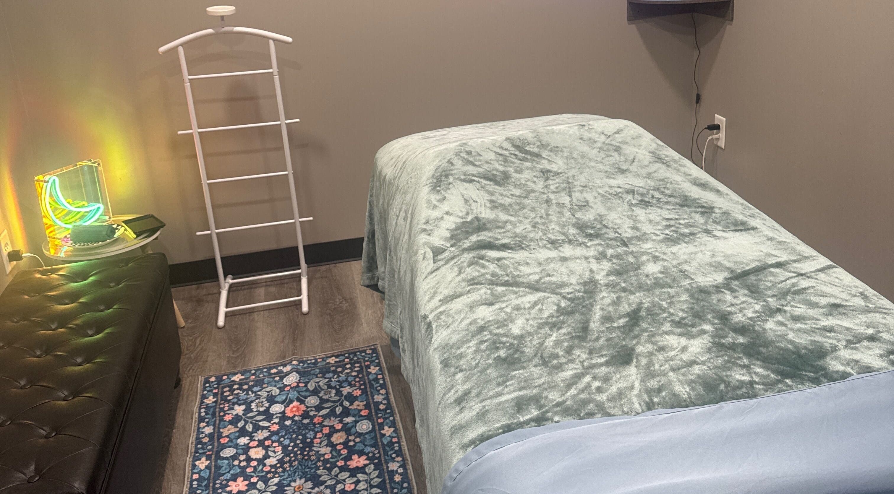 Cozy massage room at Kingston Body Wellness, Kingston, Georgia, US with plush bedding and calming decor.