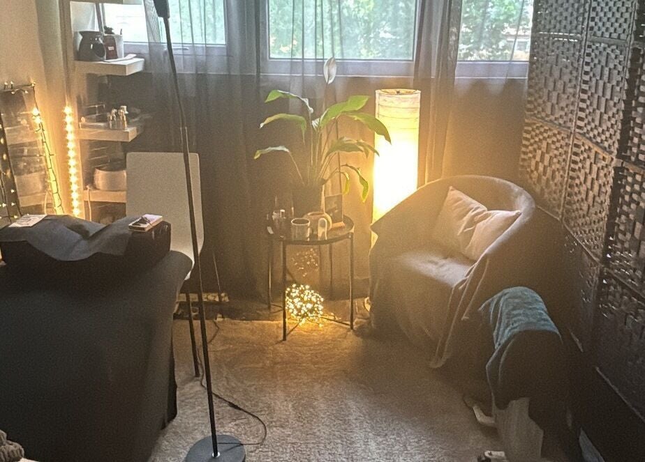 Cozy treatment room at Beauty Izz, Fullers Slade, England, GB with warm lighting and comfortable seating.