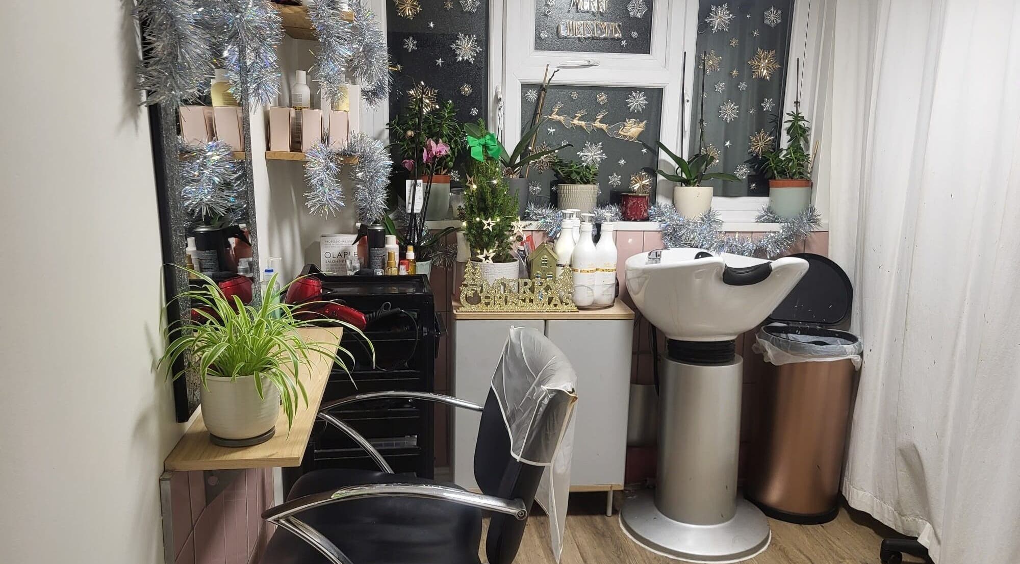 Festively decorated salon at Hair by Elena P in London, England, GB, showcasing a welcoming haircut station.