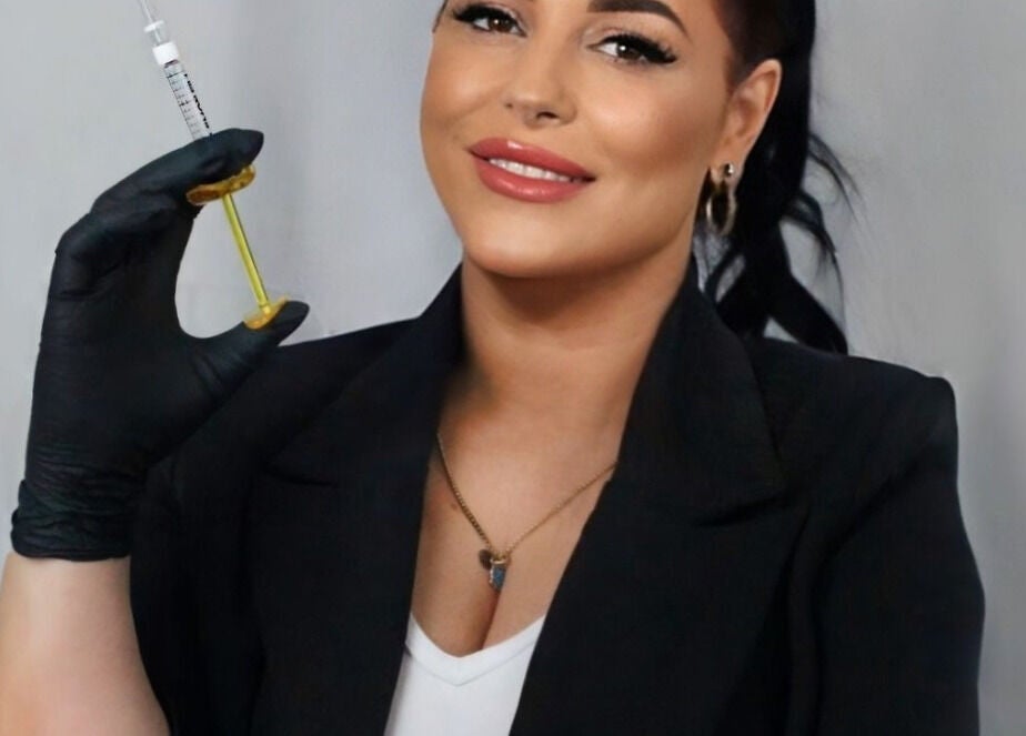 Aesthetic specialist at Tiptoe Beauty and Aesthetic's, Nuneaton, England, GB, holding a treatment syringe.