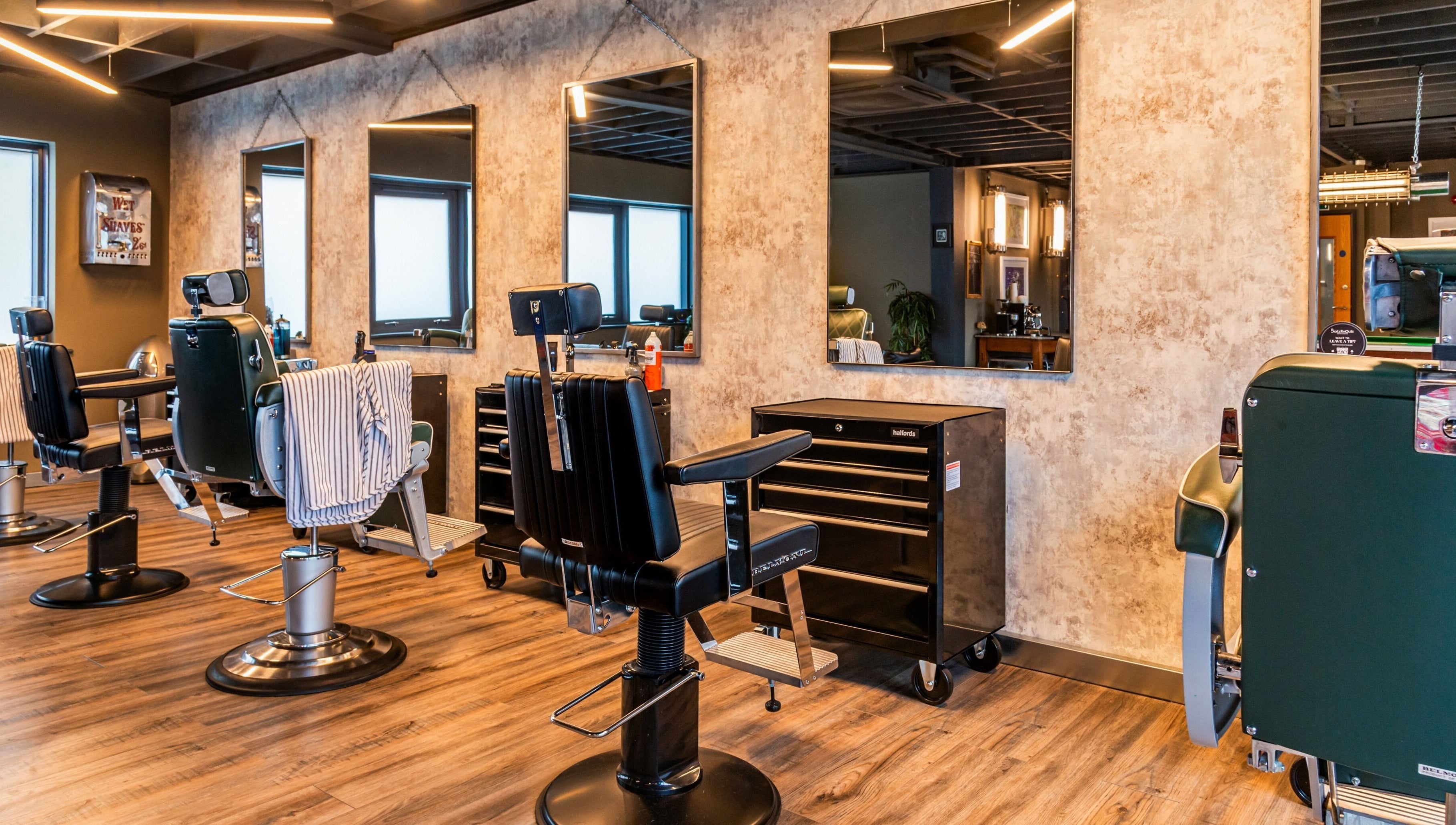 Modern barber chairs and mirrors at Boilerhouse Gentleman - Ouseburn in Newcastle upon Tyne, England, GB.
