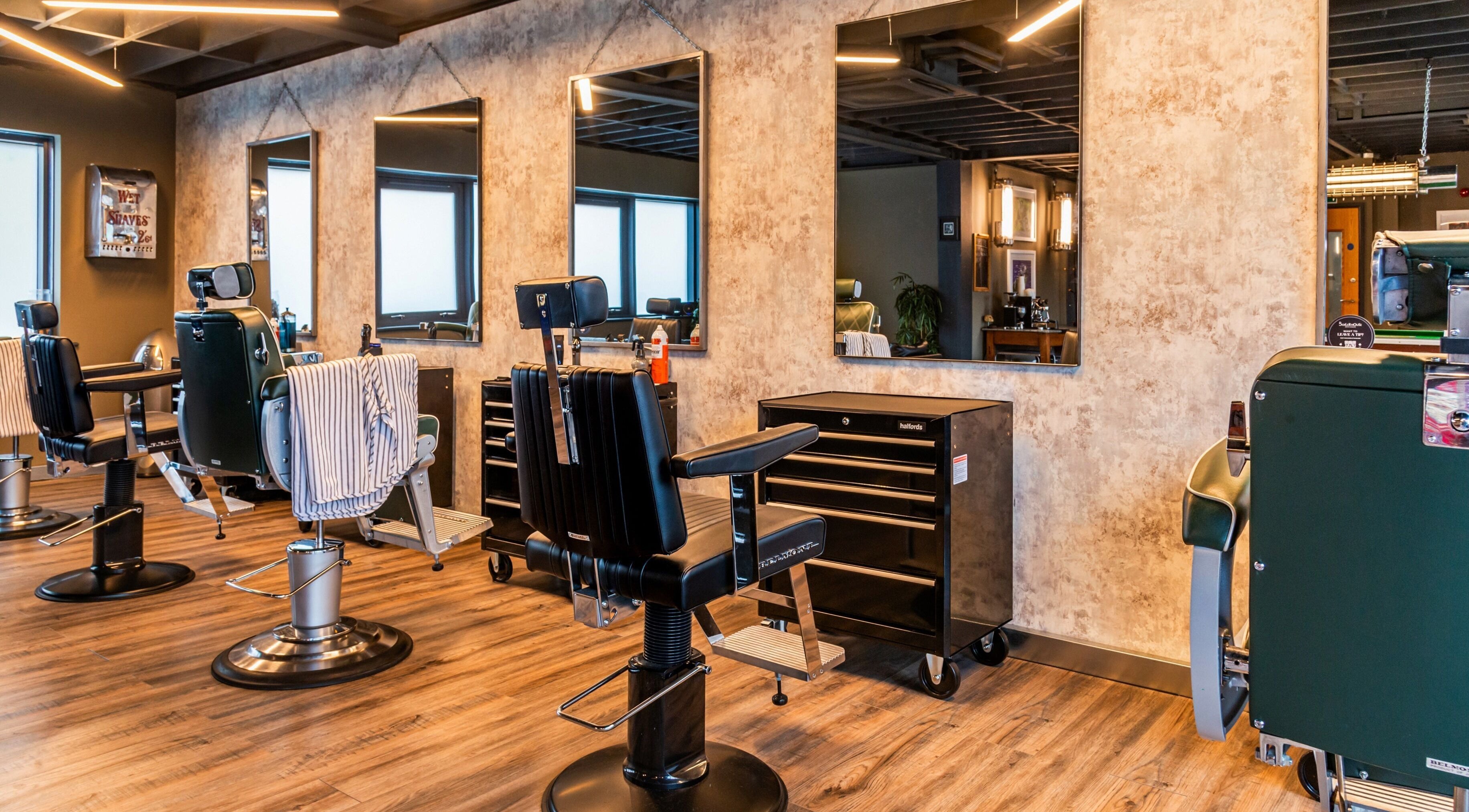 Modern barber chairs and mirrors at Boilerhouse Gentleman - Ouseburn in Newcastle upon Tyne, England, GB.
