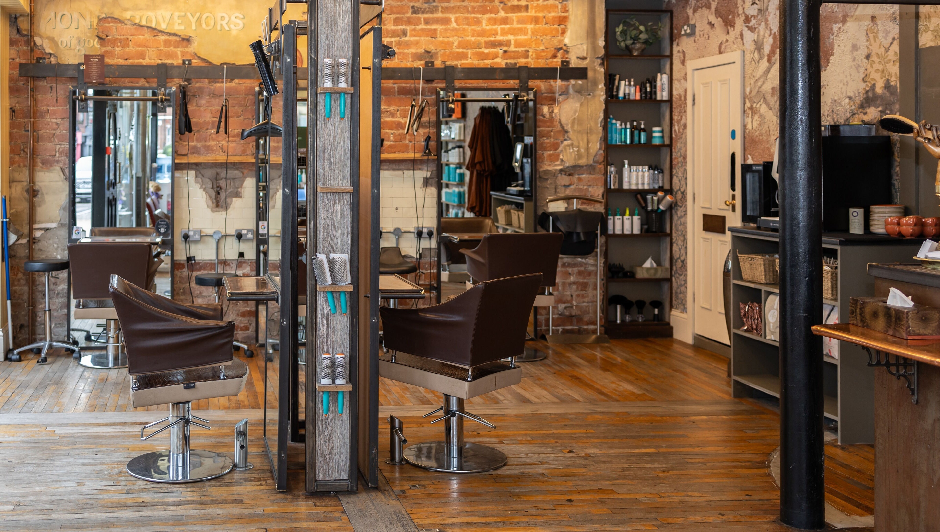 Interior of Boilerhouse - Jesmond in Newcastle upon Tyne, England with exposed brick, styling chairs, and shelves.
