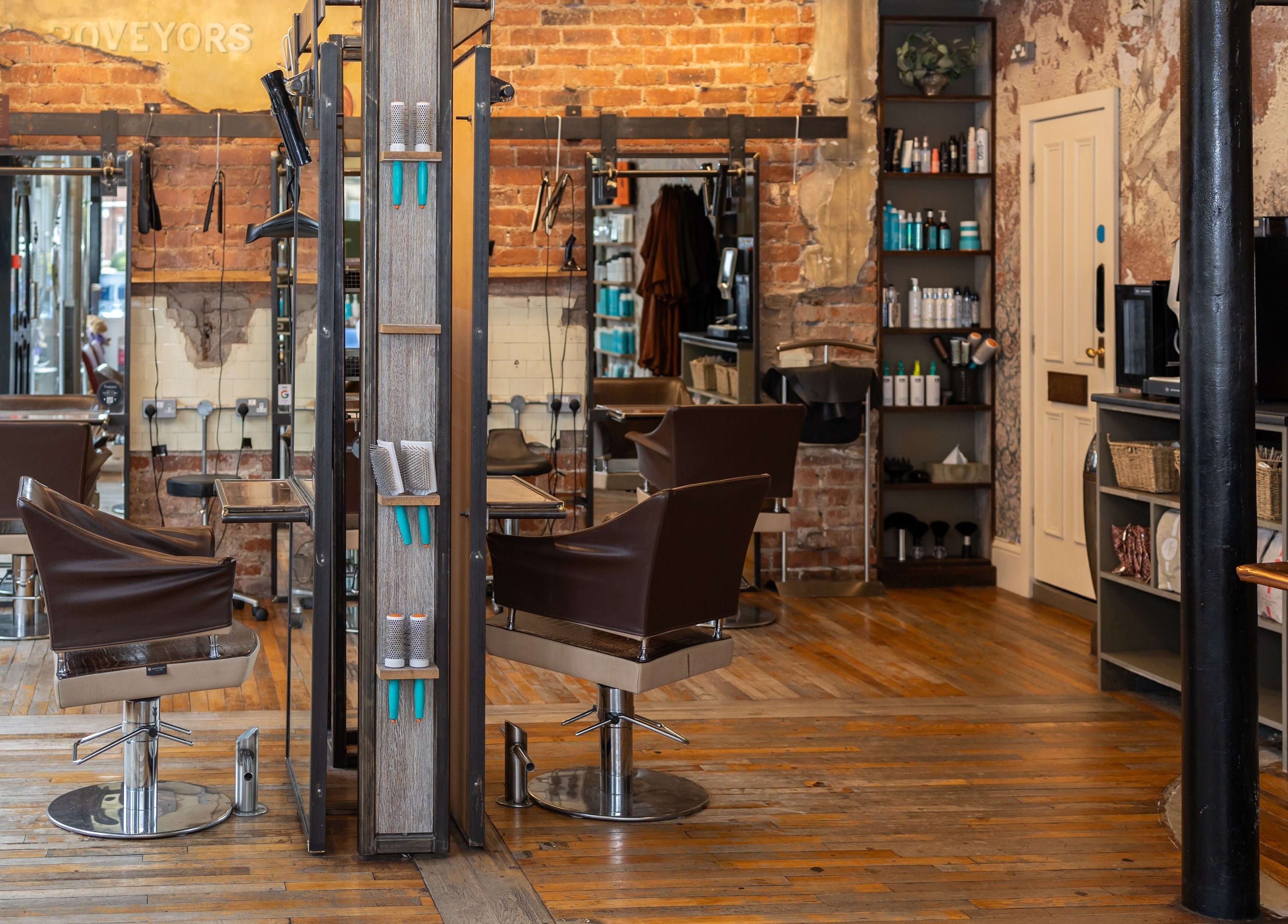 Interior of Boilerhouse - Jesmond in Newcastle upon Tyne, England with exposed brick, styling chairs, and shelves.
