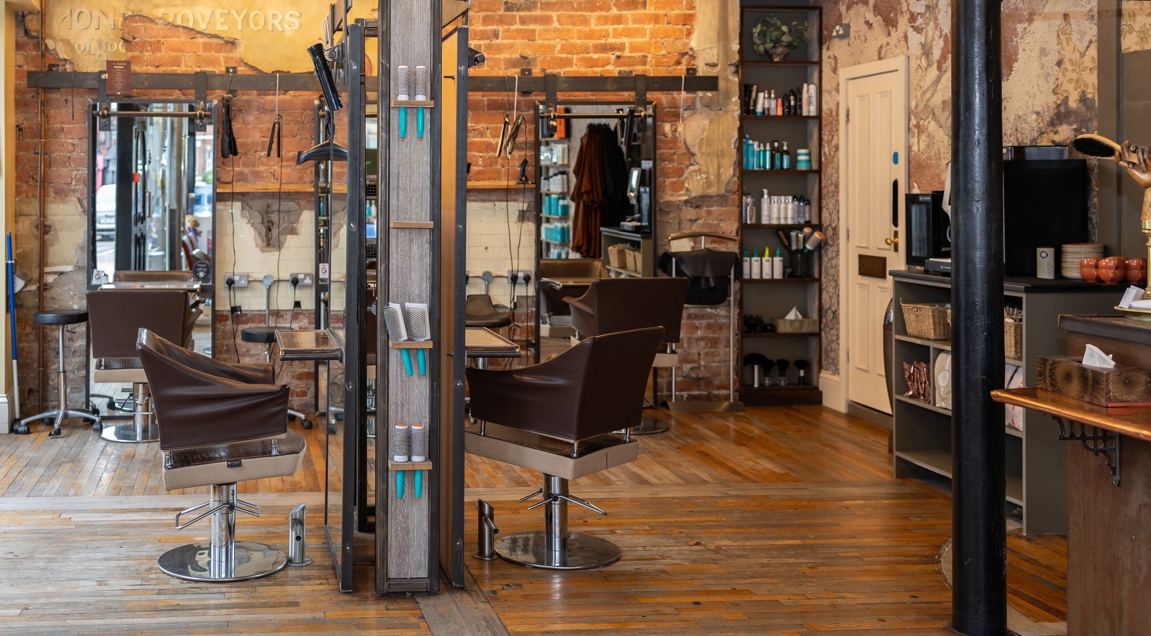 Interior of Boilerhouse - Jesmond in Newcastle upon Tyne, England with exposed brick, styling chairs, and shelves.