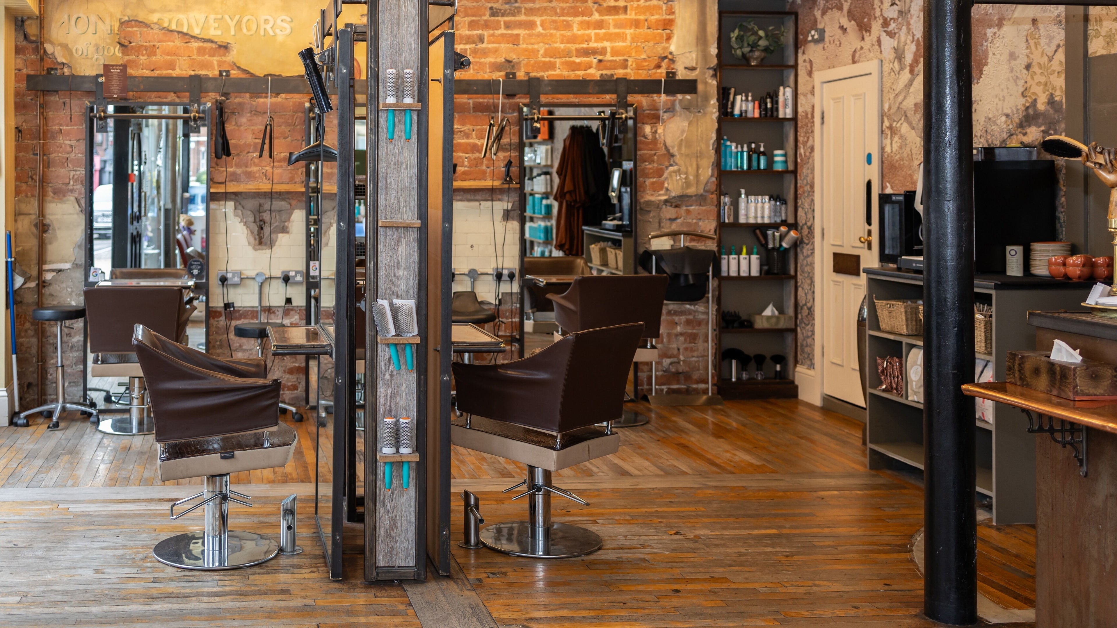 Interior of Boilerhouse - Jesmond in Newcastle upon Tyne, England with exposed brick, styling chairs, and shelves.