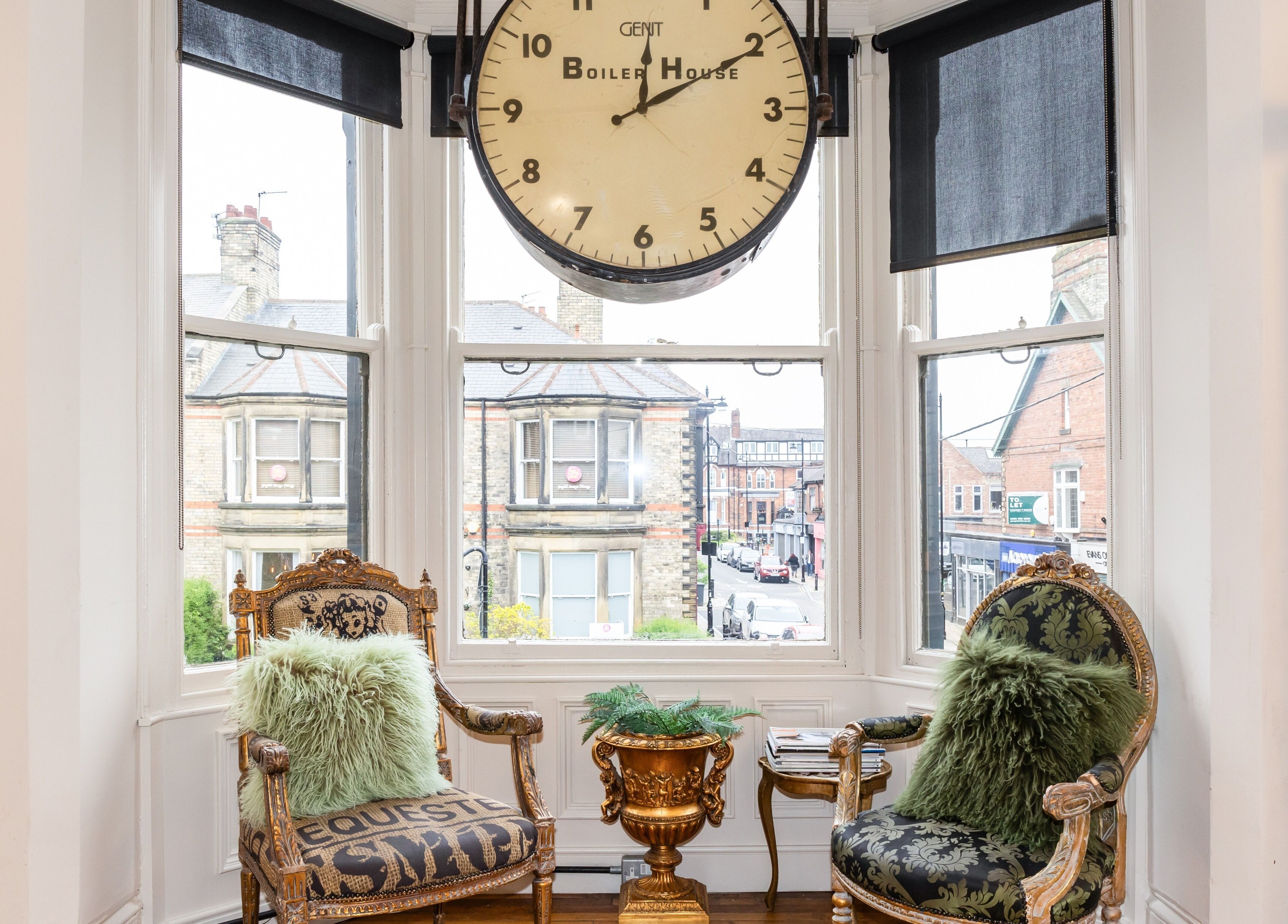 Elegant seating area with vintage clock at Boilerhouse - Jesmond, Newcastle upon Tyne, England, GB.