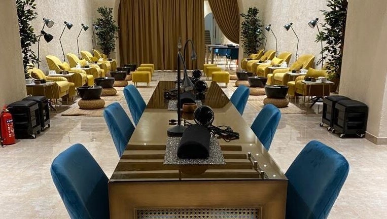 Elegant interior of The Bliss Nails in Riyadh, SA with plush seating and nail stations.