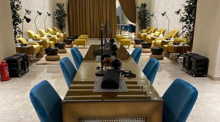 Elegant interior of The Bliss Nails in Riyadh, SA with plush seating and nail stations.