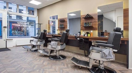 Interieur van Rembrandt Barbershop in Leiden, Zuid-holland, NL met moderne kappersstoelen en spiegels.