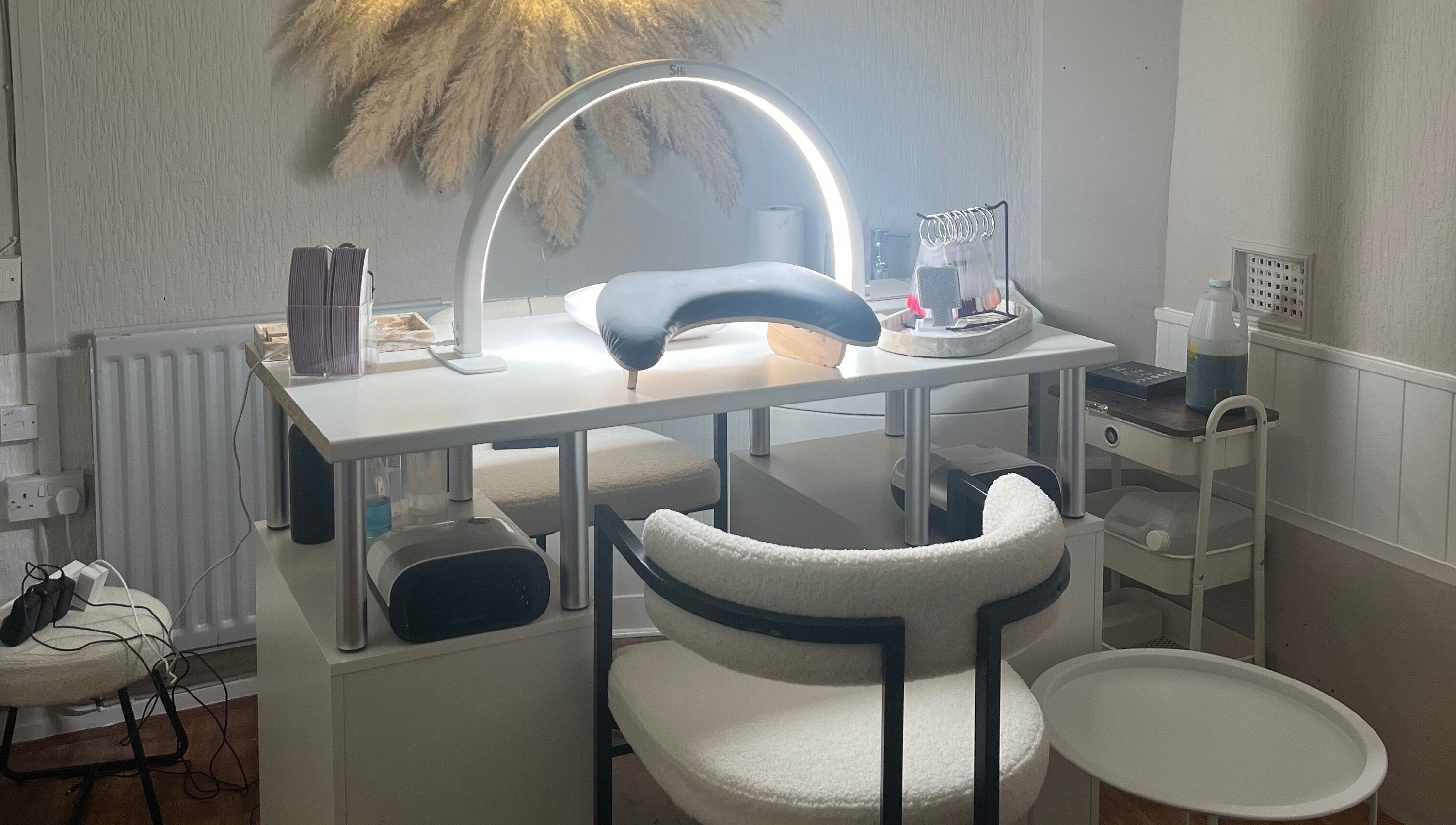Elegant nail care setup at Bella by Ella, Douglas, with modern lighting and tools.