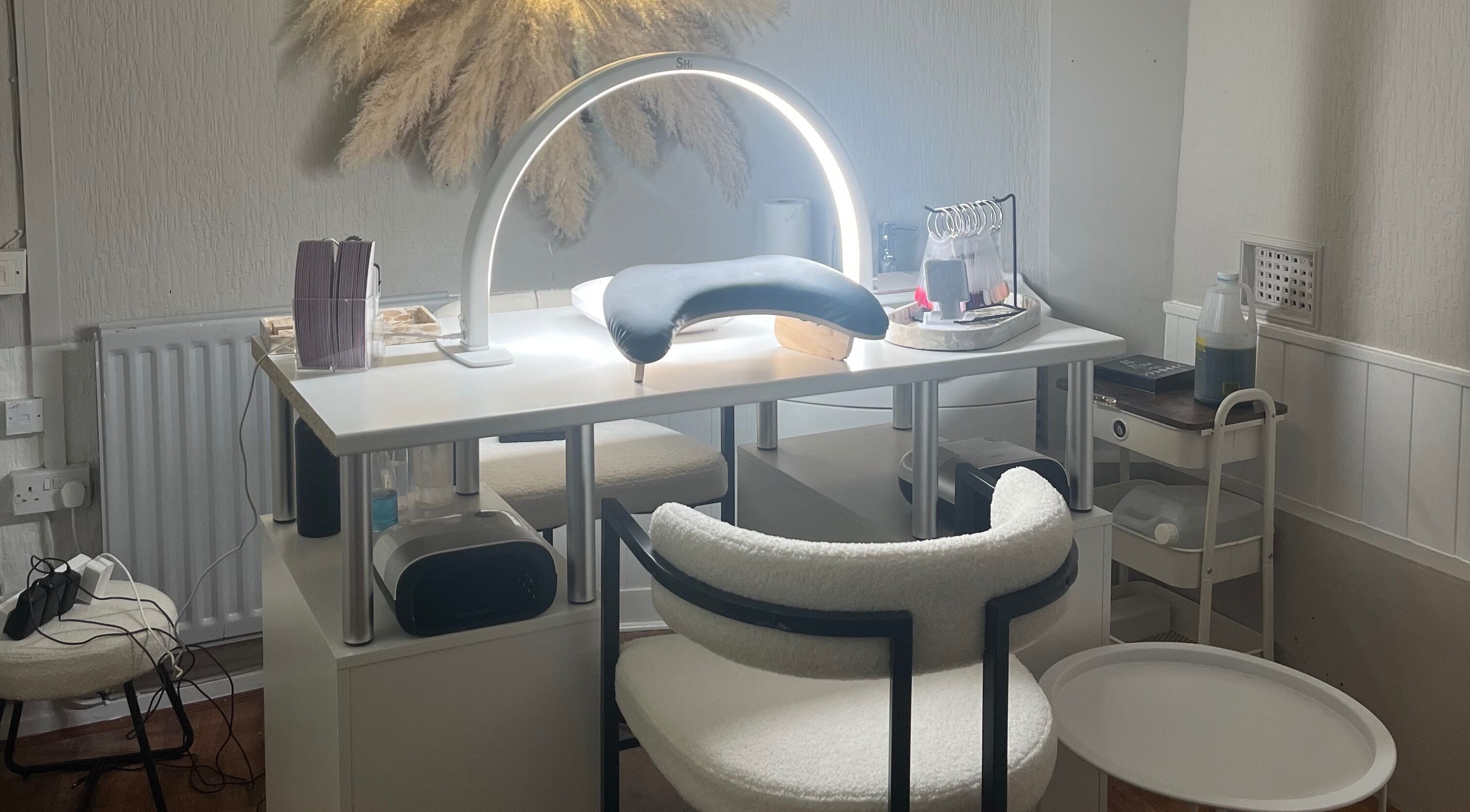 Elegant nail care setup at Bella by Ella, Douglas, with modern lighting and tools.