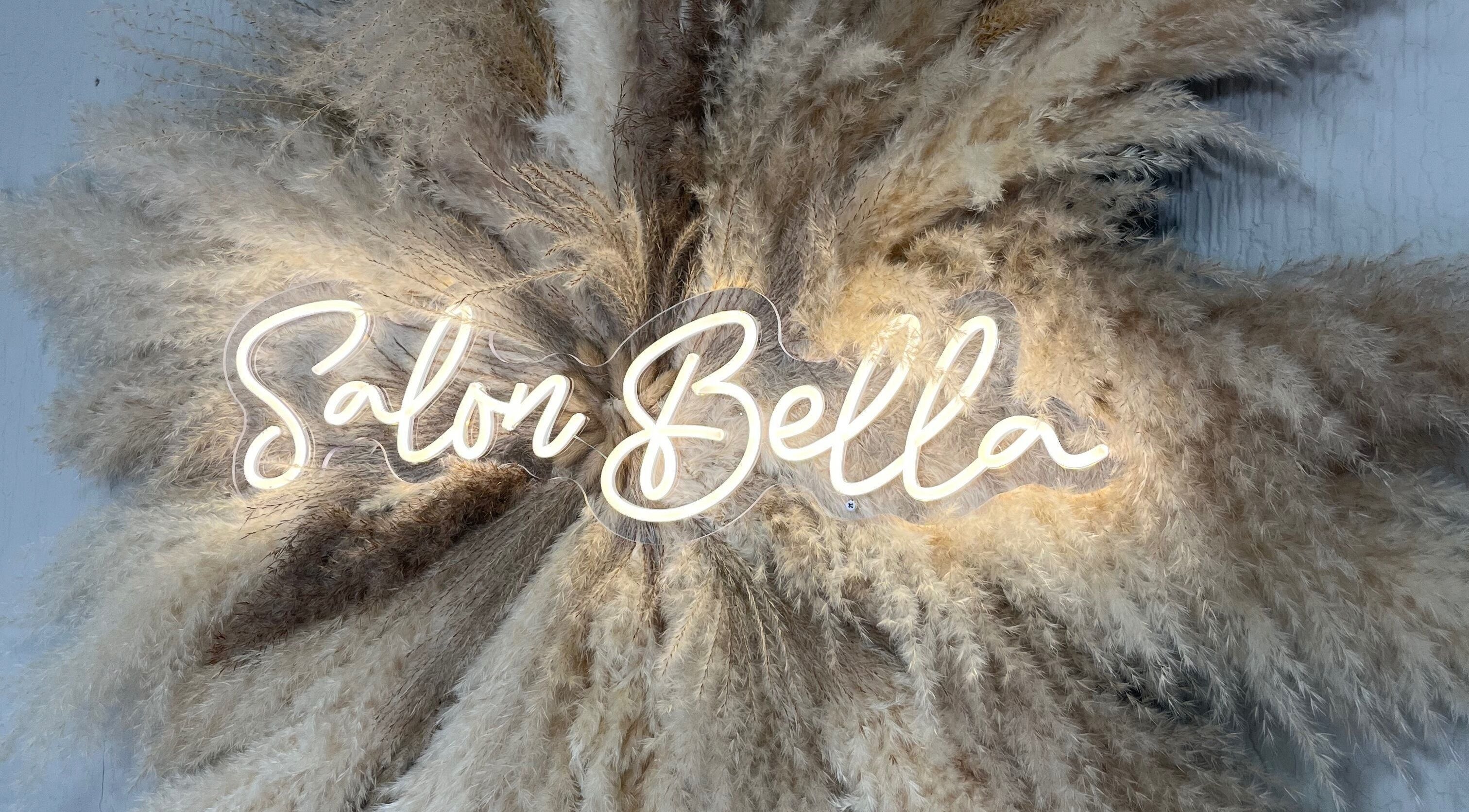 Elegant 'Salon Bella' neon sign surrounded by pampas grass at Bella by Ella, Douglas, Douglas, IM.