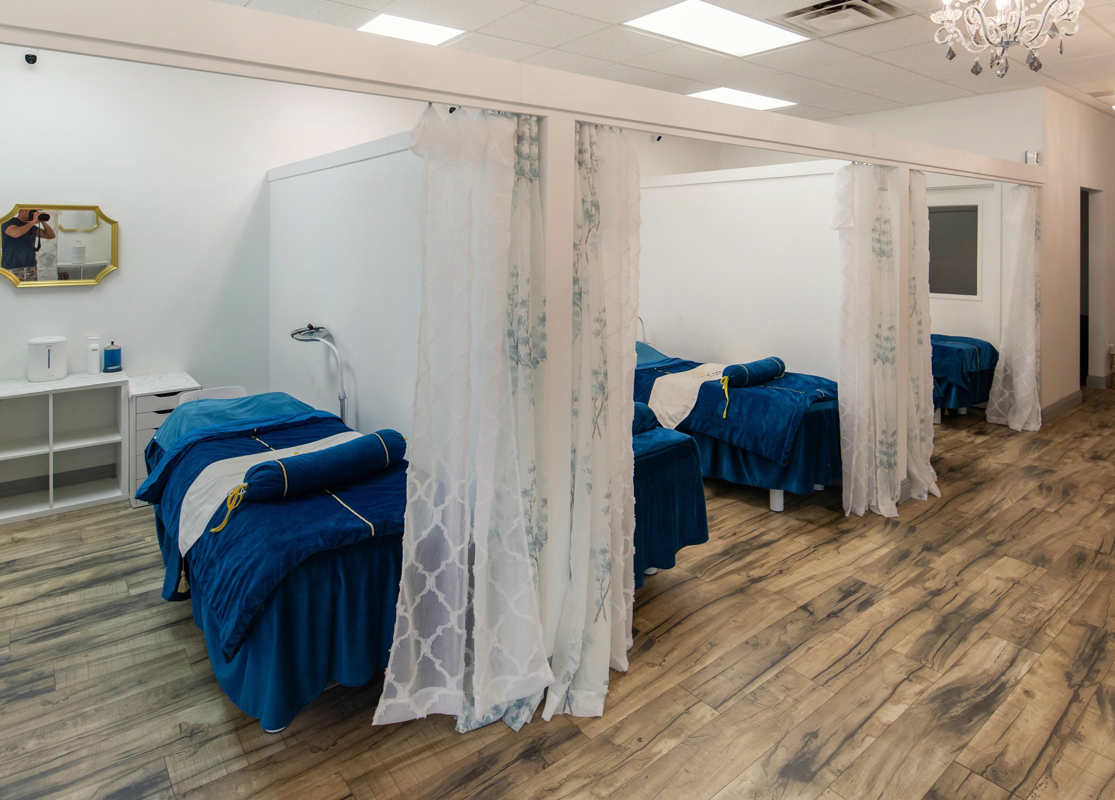Luxurious treatment rooms at I Lash For U in Saratoga Springs, Utah, US with plush blue bedding.