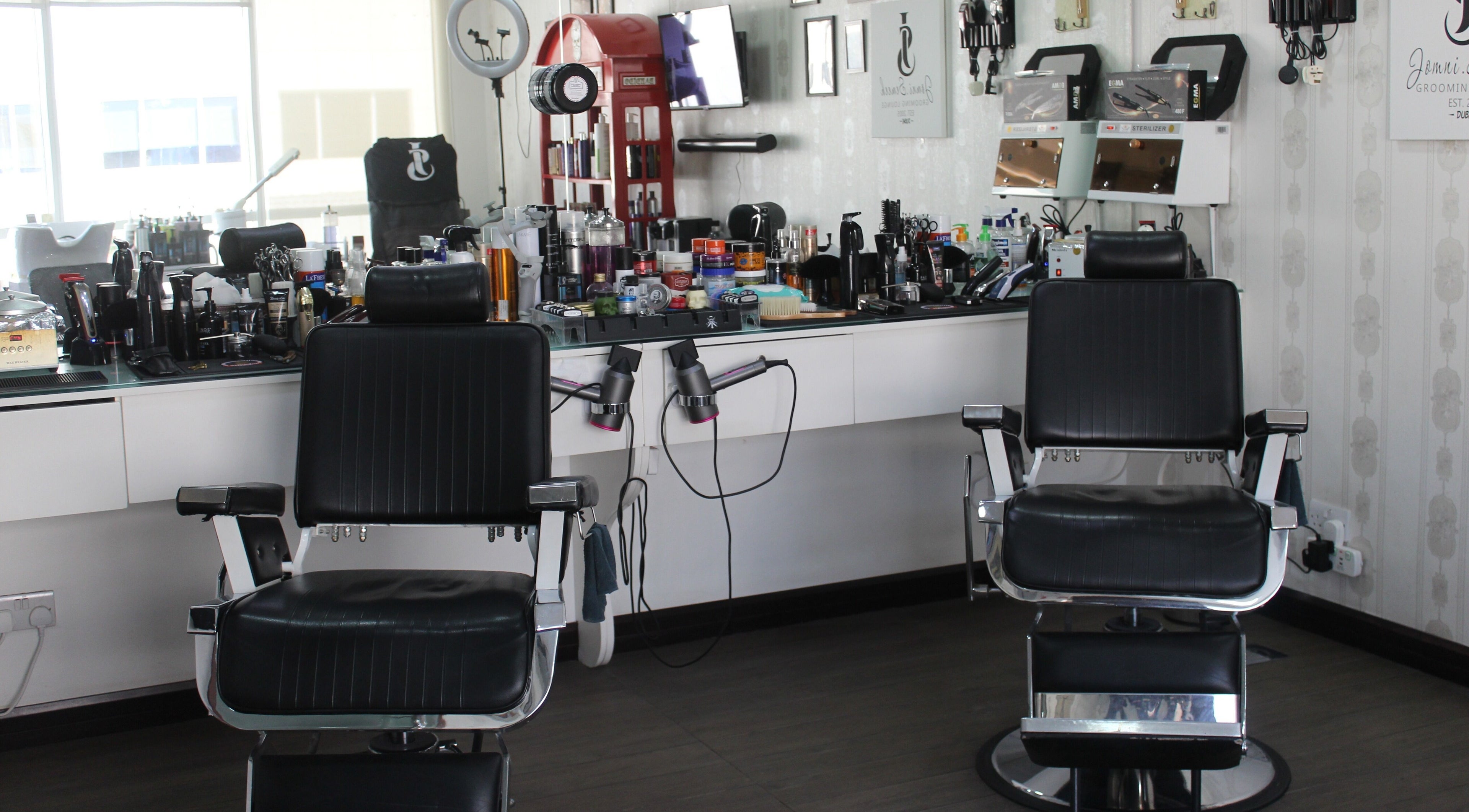 Elegant barber chairs at Jomni Semeeh Grooming Lounge in Dubai, Dubai, AE, showcasing a modern grooming space.