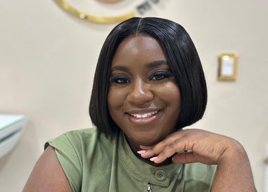 Smiling woman at Skin Muse, Bon Accord, Western Tobago, TT, showcasing a radiant, professional look.
