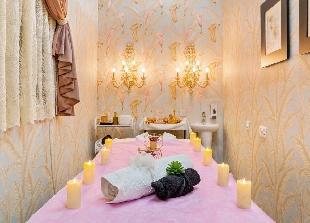 Relaxing spa room at BellaVie Beauty Salon and Spa, Dubai, AE, featuring candles and elegant decor.