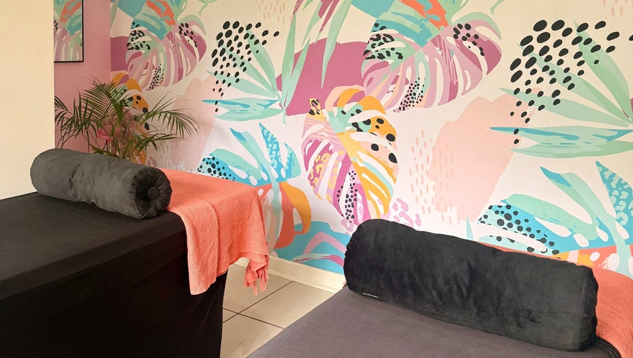 BM Pressed's vibrant floral wellness room in Westville, Kwazulu-natal, ZA, featuring colorful wall art and spa beds.