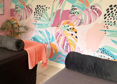 BM Pressed's vibrant floral wellness room in Westville, Kwazulu-natal, ZA, featuring colorful wall art and spa beds.